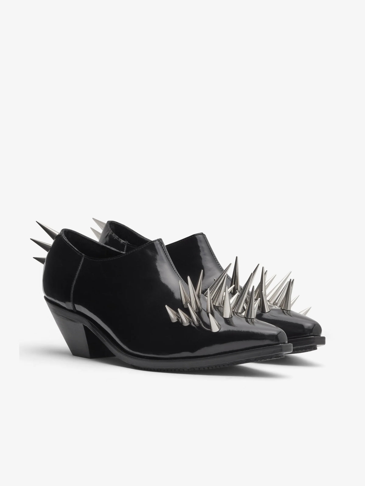 Junya Watanabe Women's Spiked Leather Shoes in Black, angled view showing the side zip closure, pointed toe and metallic spike detailing.