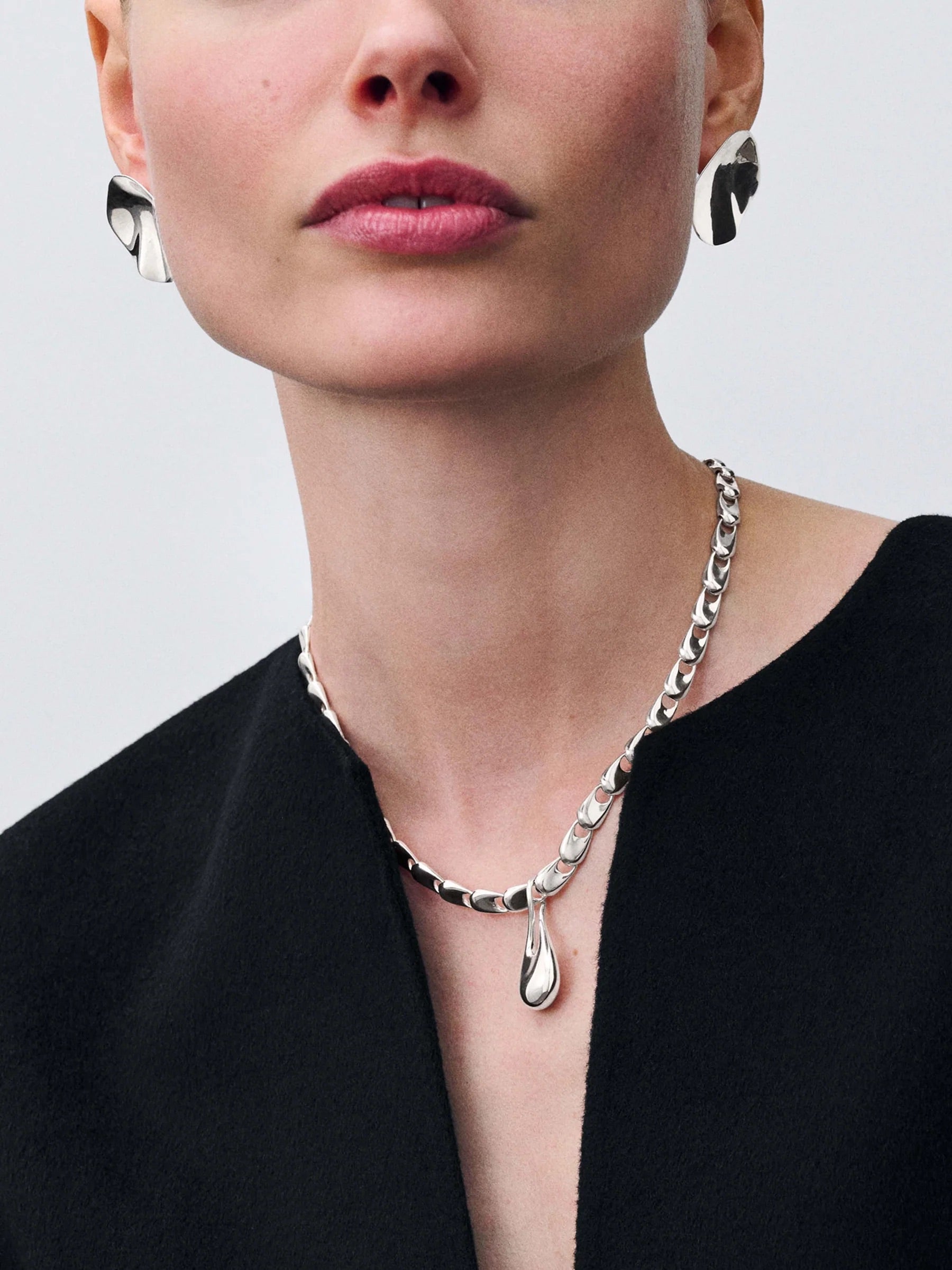 Model wearing Kinraden Mini Electra Necklace Large in recycled sterling silver with pendant necklace layered below