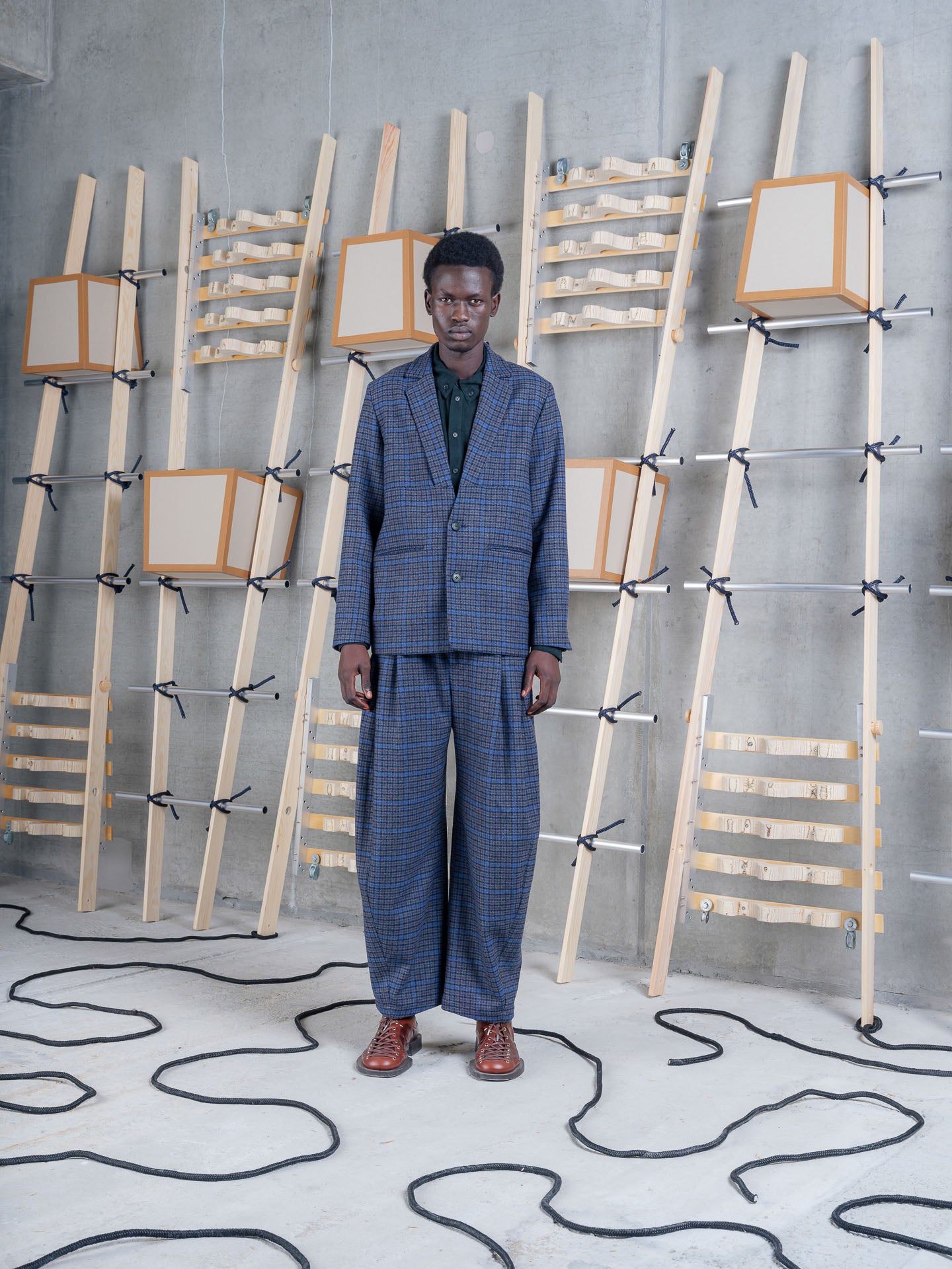 Model wearing Henrik Vibskov Lonely Blazer in Blue Wool Checks, front view.
