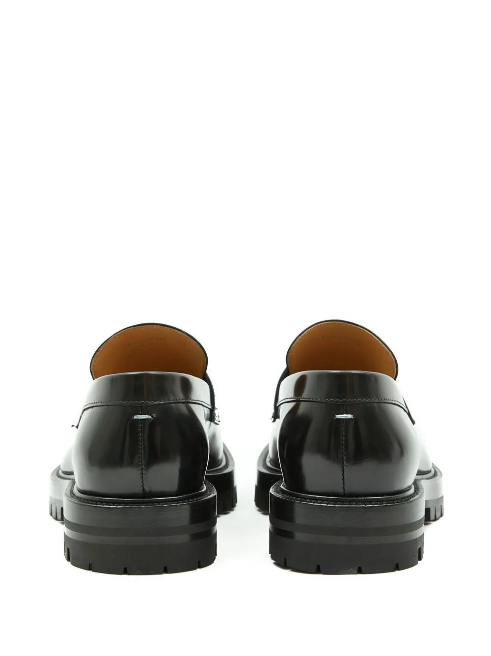Black shoes with brown soles on a white background