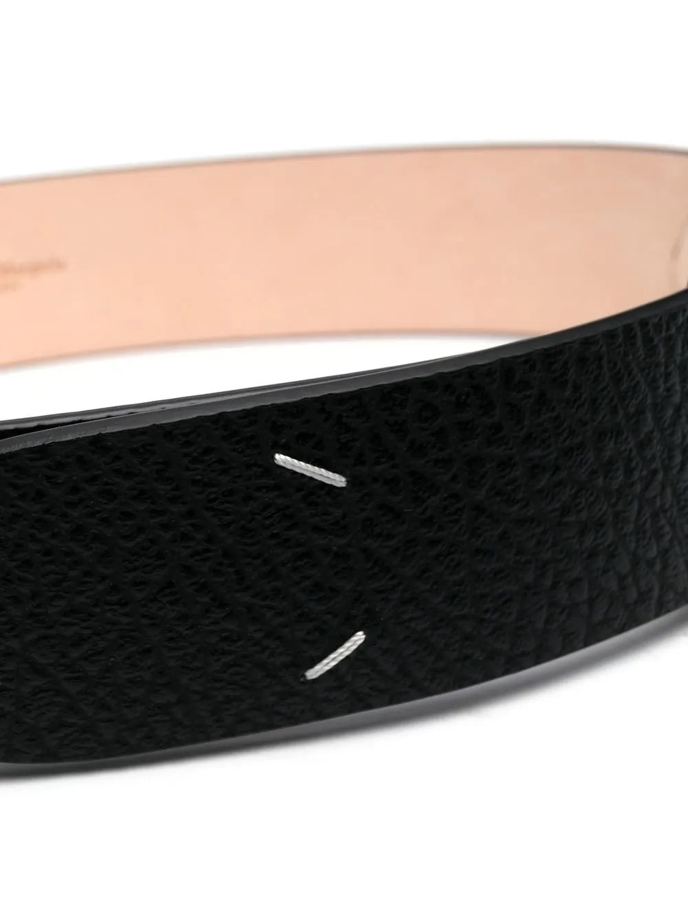 Close-up of the black belt featuring four white stitches from Maison Margiela on a white background