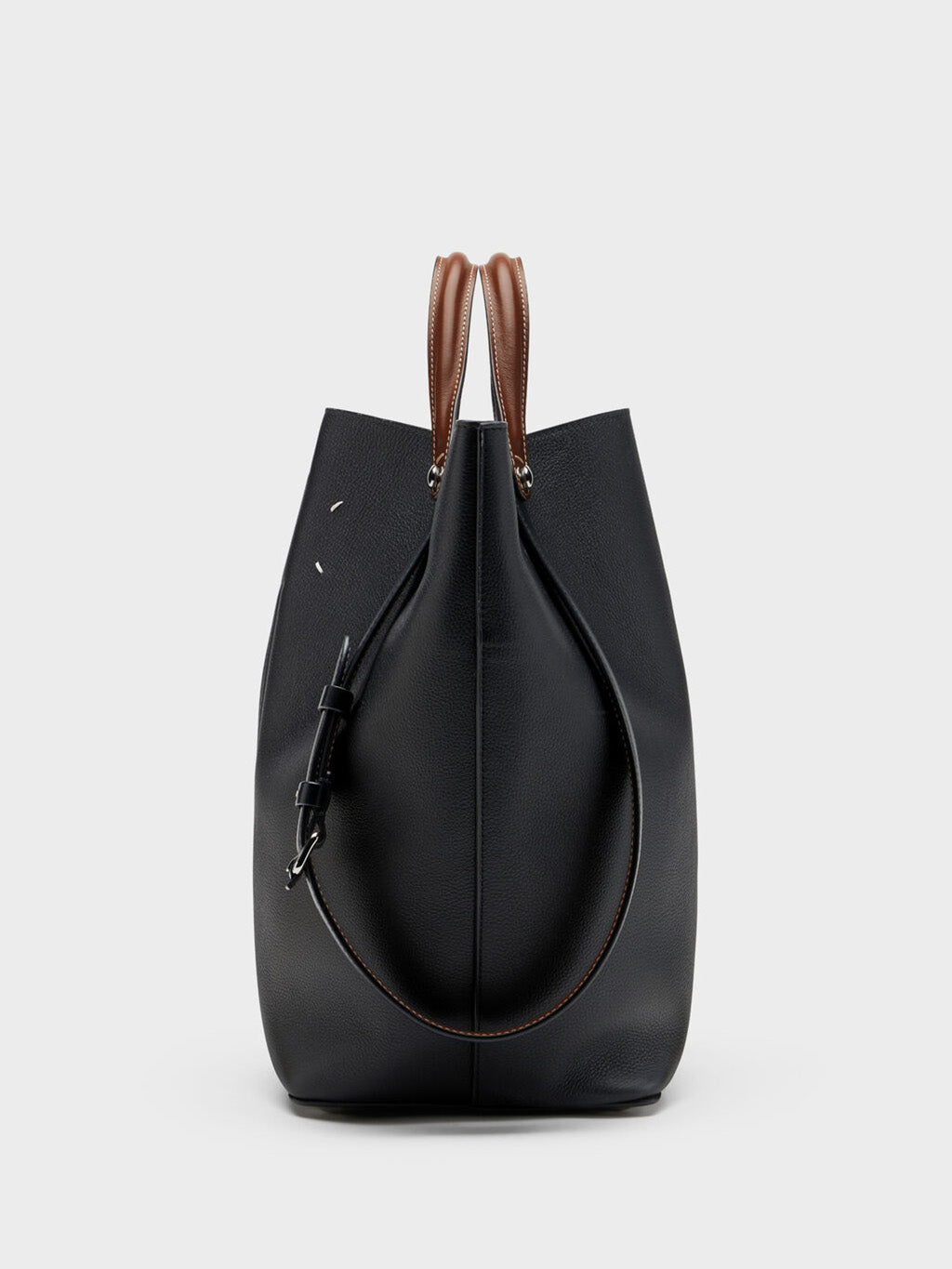 Maison Margiela Dress-Age Medium black and chestnut, side-back view showing trapezoid silhouette and adjustable strap with buckle