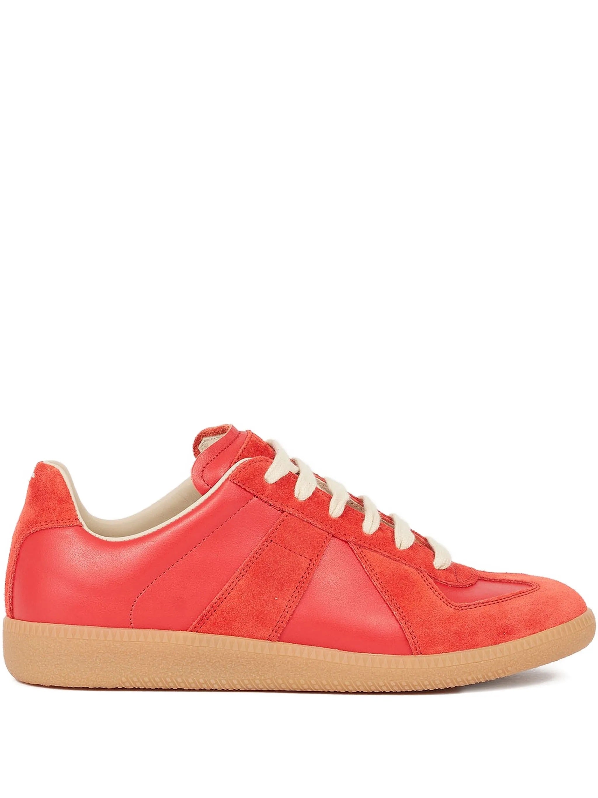 Red sneaker with white laces on a white background