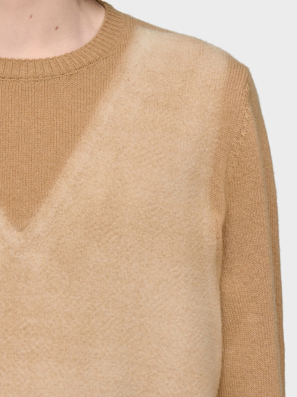 Close-up of Maison Margiela Fused Knit Wool Crewneck Sweater showing needle-punched trompe l'oeil V-neck detail in lighter camel tone