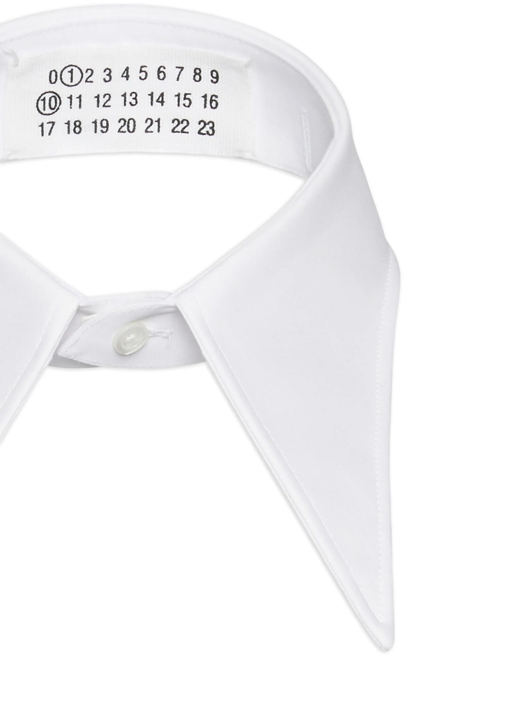 Close-up of a white shirt collar with label details on a white background