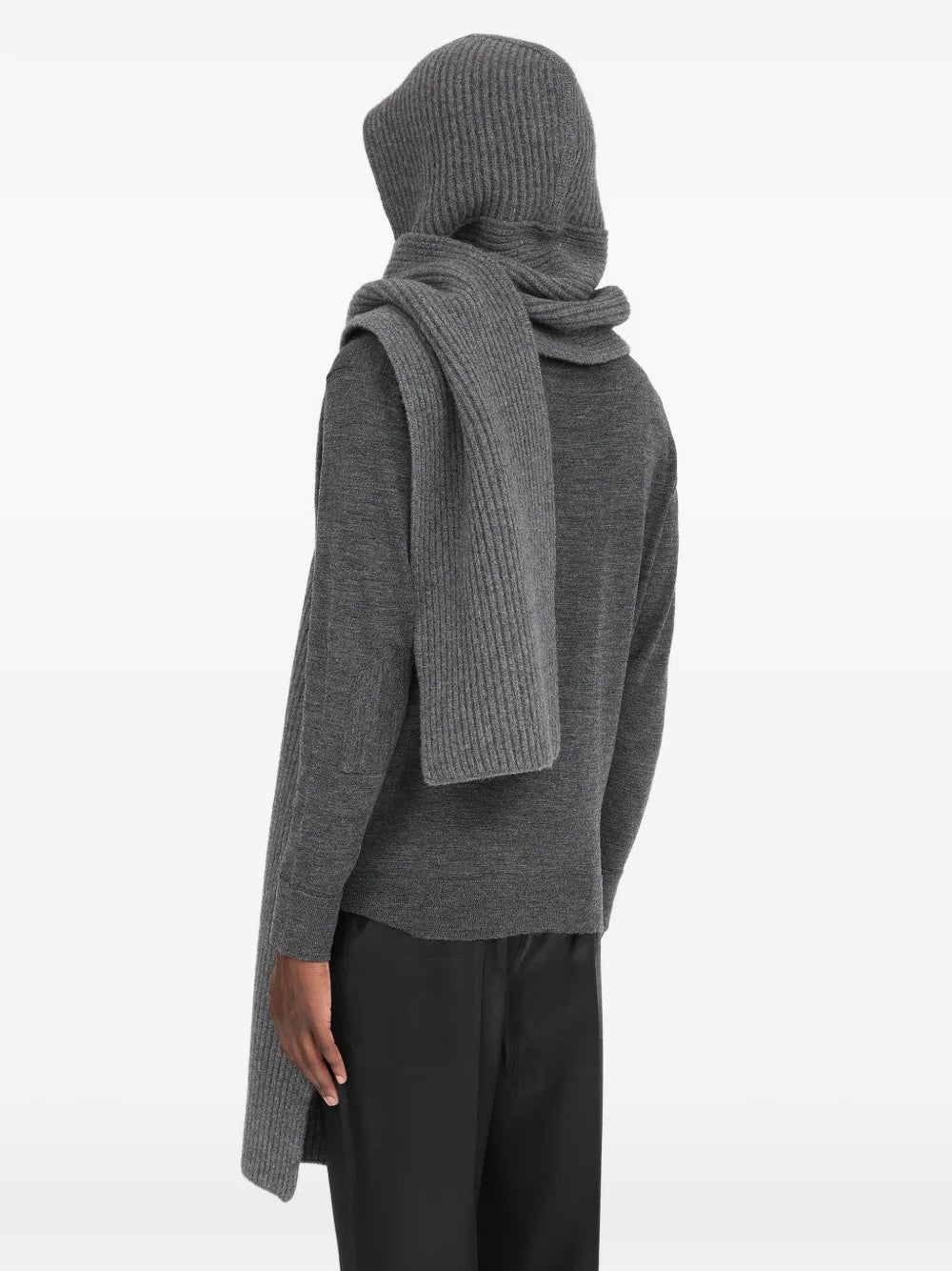 Back view of a model wearing the dark grey Maison Margiela hooded scarf, showing the hooded silhouette and ribbed knit texture.