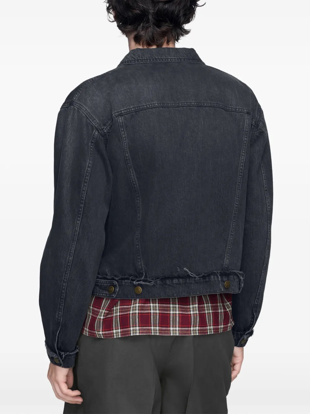 Close-up back view of the model wearing the washed black Maison Margiela sports jacket, highlighting the denim texture and construction details.