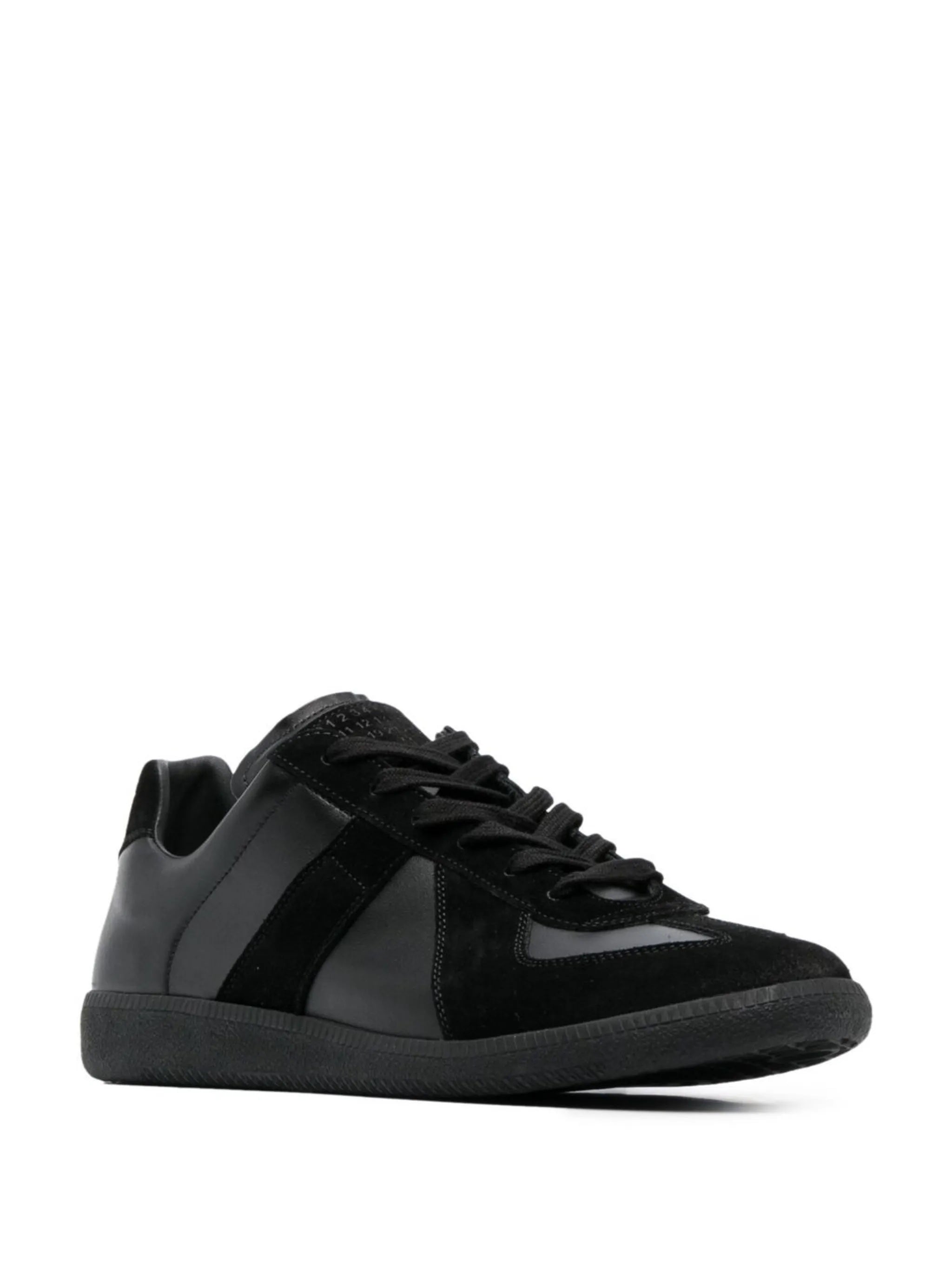 Side view of an all black leather sneakers with panel design from Maison Margiela on a white background