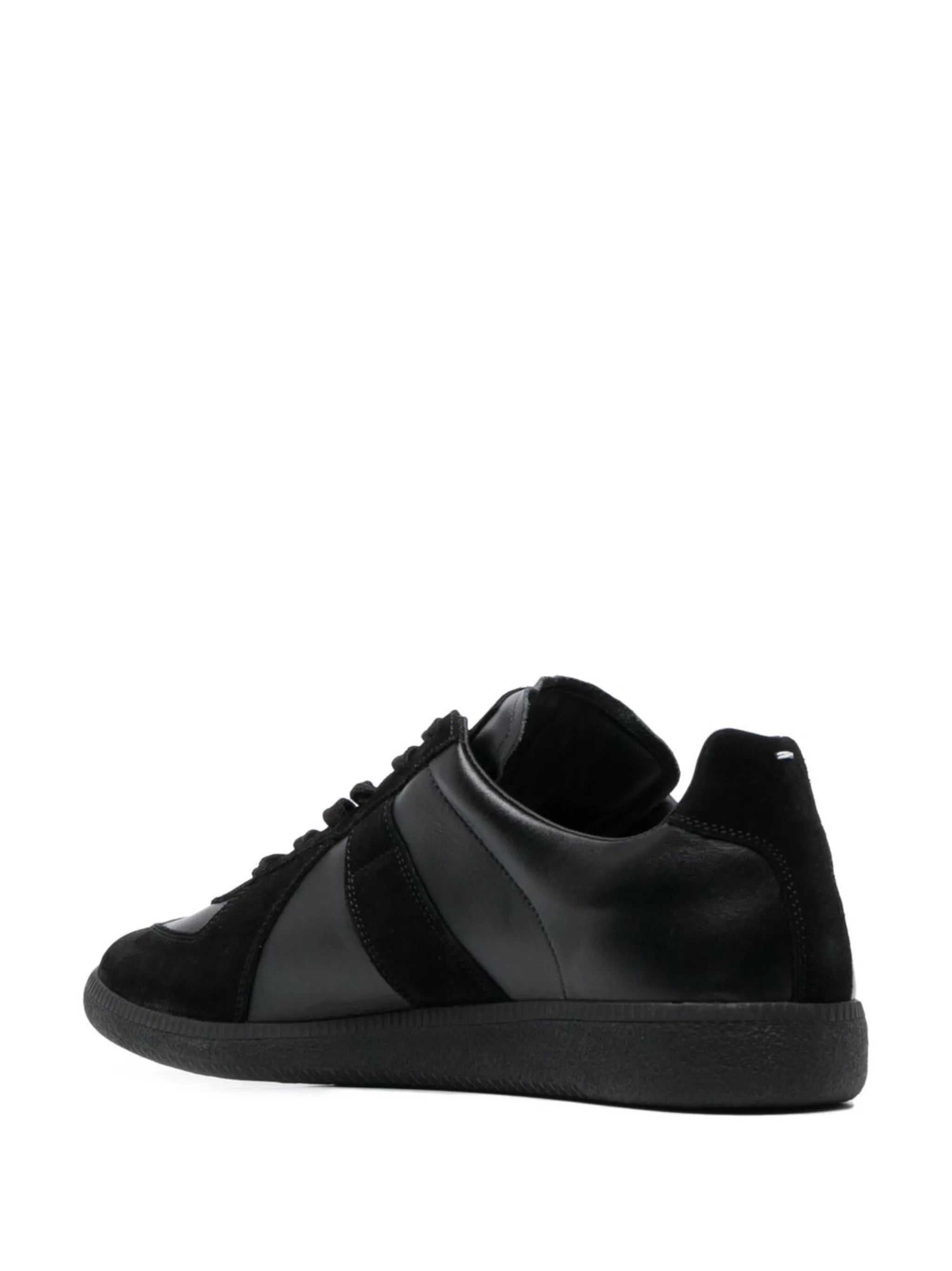 Back view of the all black leather sneakers with white stitch detail from Maison Margiela on a white background