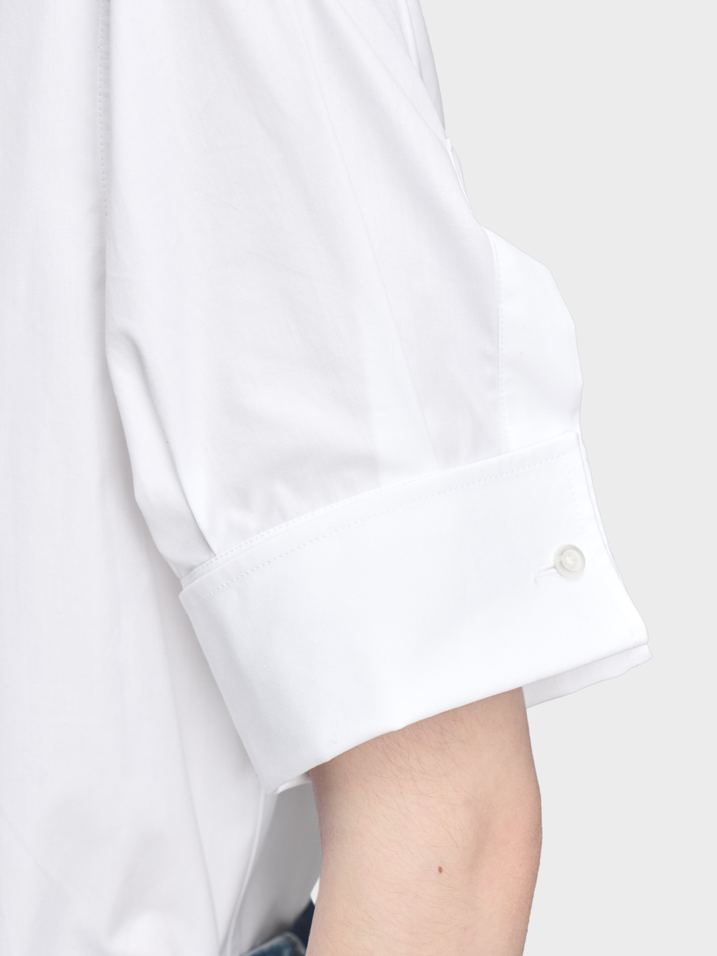 Maison Margiela Snapped Button Short Sleeves Shirt in White, close-up of deep turn-back cuff, crisp white cotton, precise tailoring detail