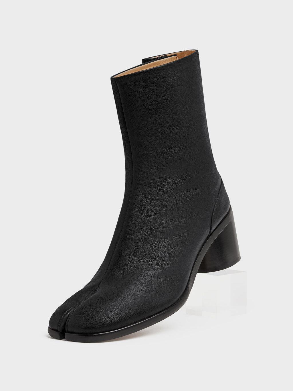 Maison Margiela Tabi Ankle Boot H60 in Black, three-quarter front view, smooth black leather upper, signature split toe, 60mm block heel, back zip fastening