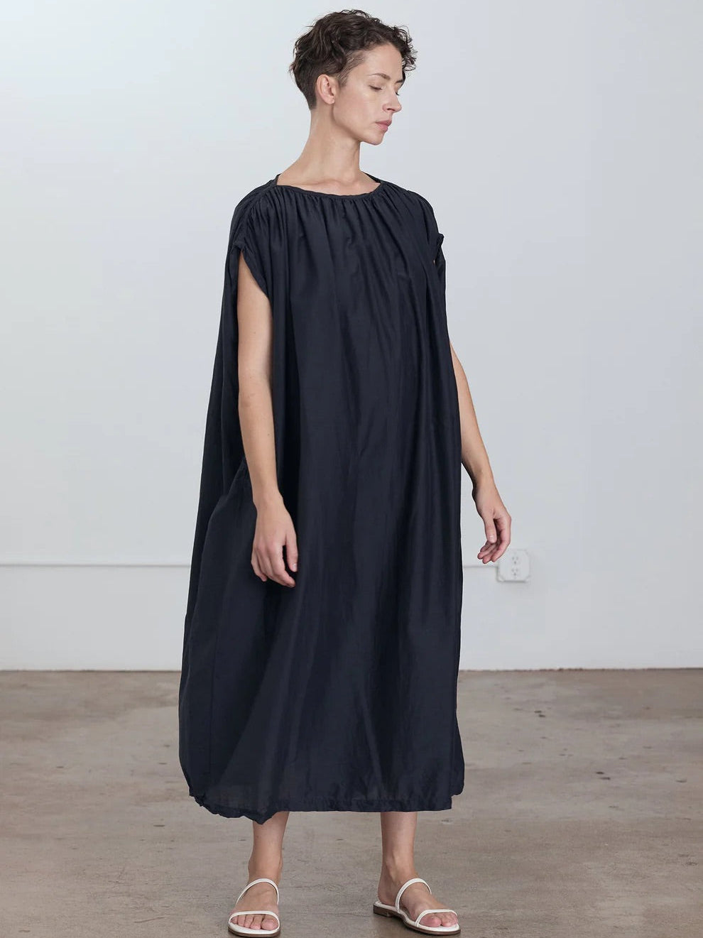 Black Crane Mont Blanc Dress in Faded Black - front view on model showing shoulder piping and shirring detail