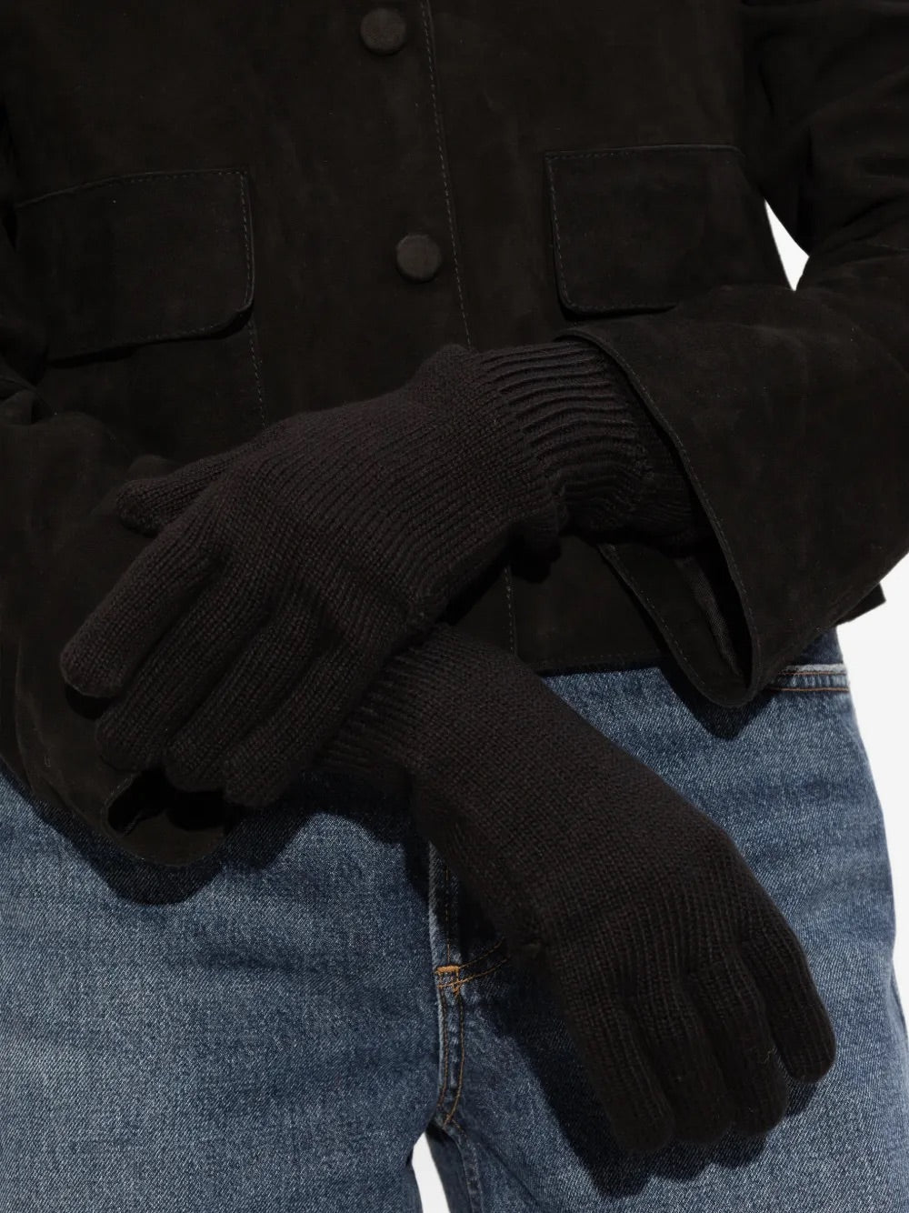 Front view of a model wearing the Issey Miyake AW25 Breeze Knit Gloves in black, showing the fitted ribbed knit, cut-out detail, and contemporary styling on the hands.