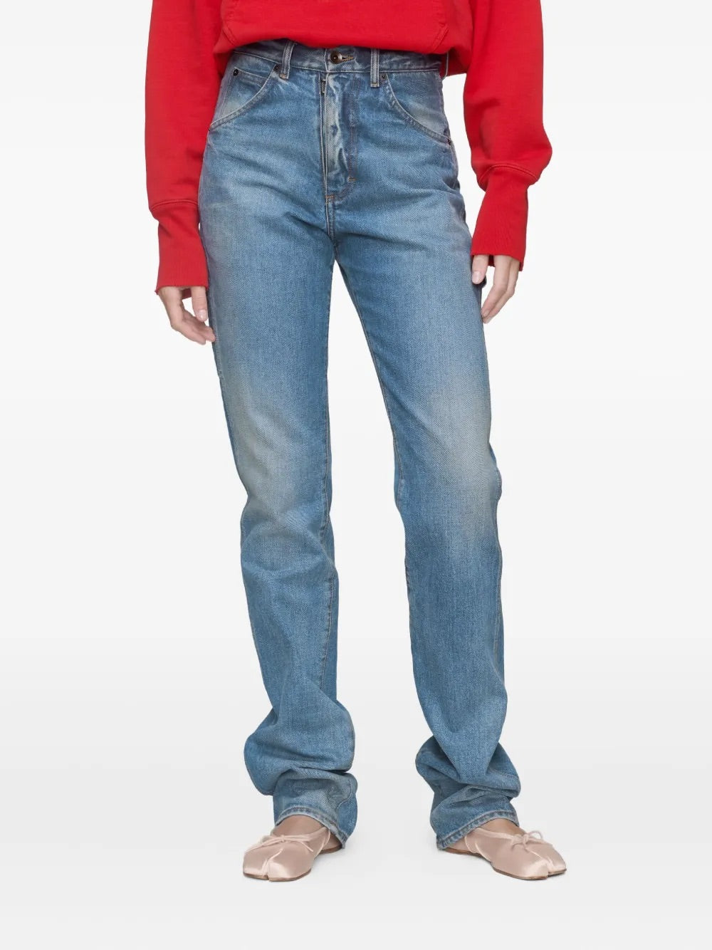 Closer front view of a female model wearing the Maison Margiela Pants 5 Pockets in Light Blue Indigo, showing the waistband, belt loops, and pocket detailing of the tailored trousers.