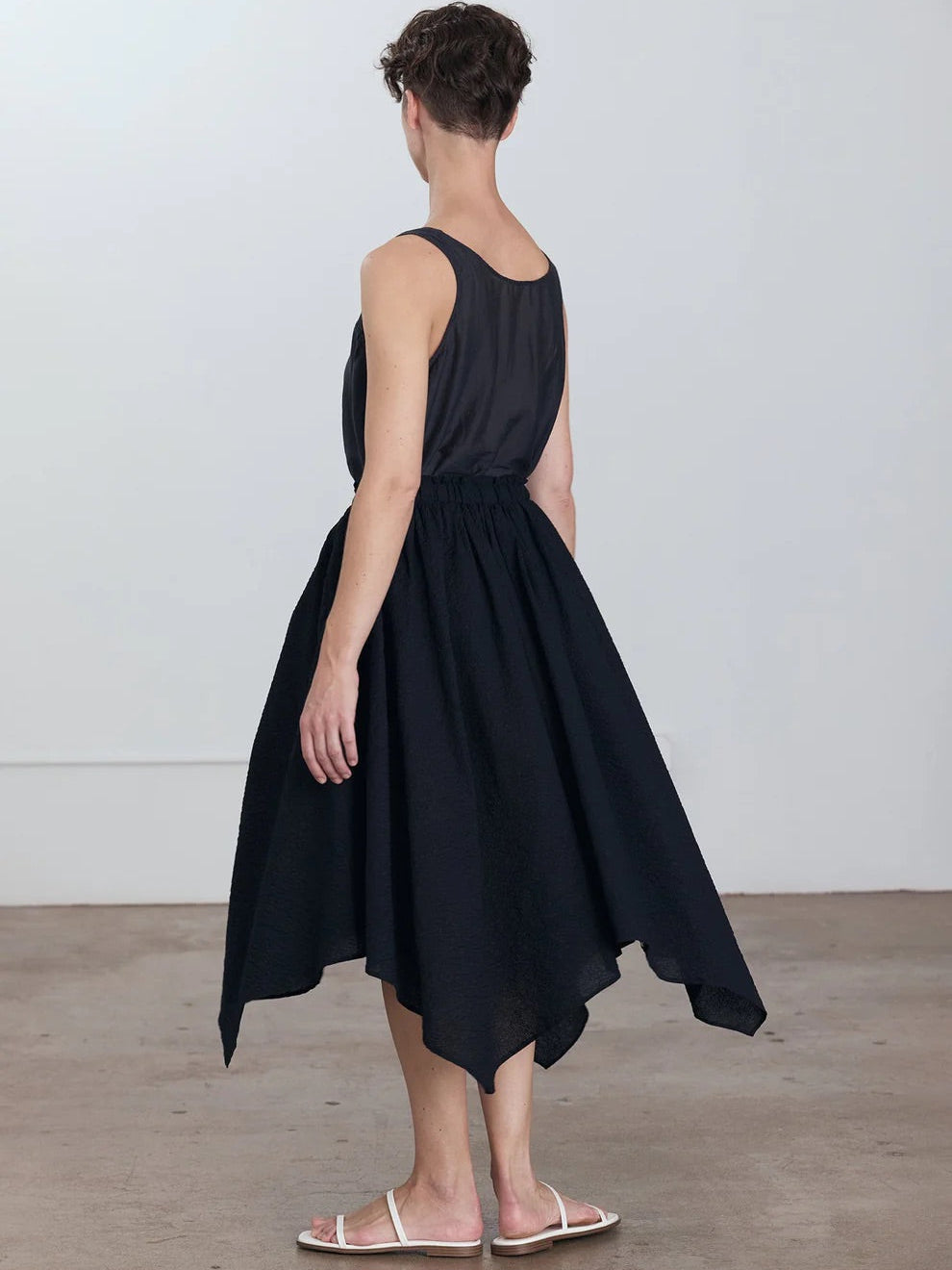 Black Crane Paper Skirt in Midnight - back view on model showing voluminous A-line silhouette and asymmetric hem