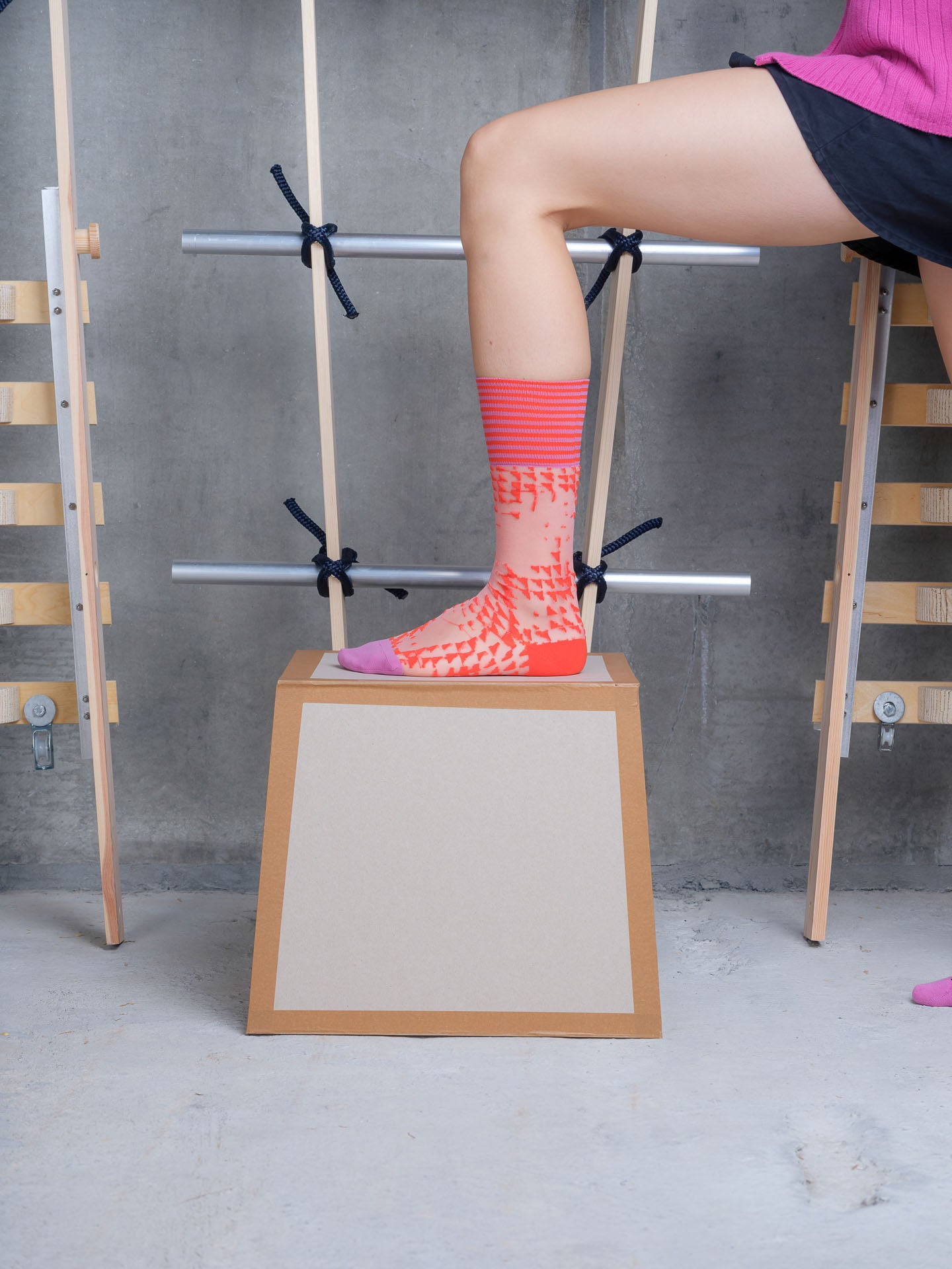 Model wearing Puzzle Knee Sock in Mandarin Purple Tiles by Henrik Vibskov