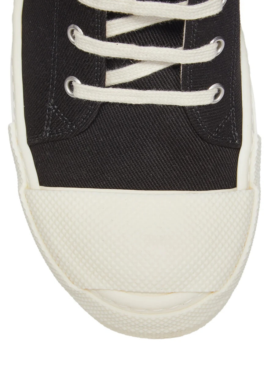 Close-up of Rick Owens DRKSHDW Tower Sneaks showing black overdyed denim upper, milk white laces and extended textured rubber toe cap