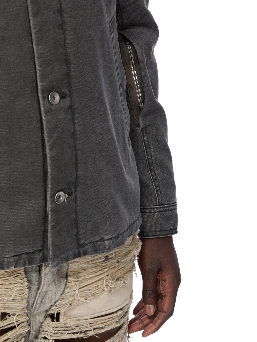 Close-up of Rick Owens DRKSHDW Brad Jacket in Gravel showing the button fastening, diagonal welt pocket and concealed zip pocket at the forearm.