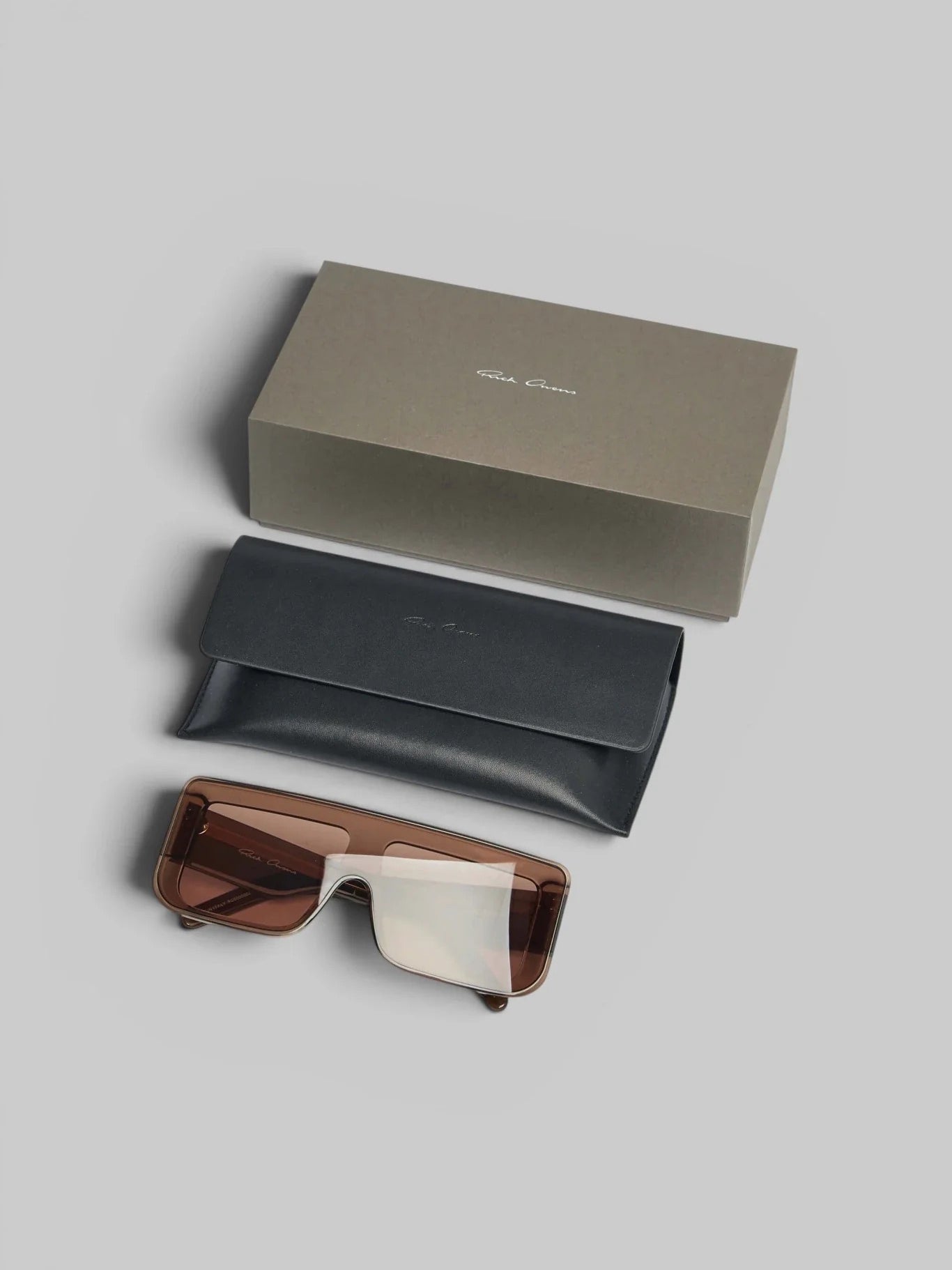 Rick Owens DRKSHDW Documenta Sunglasses shown with branded box, eyewear case and folded tobacco brown sunglasses accessories