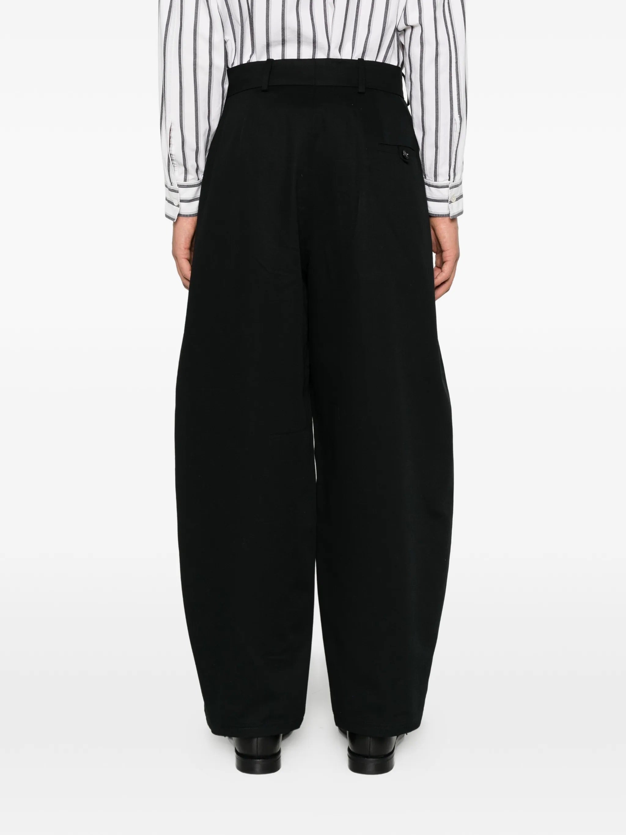 House Of The Very Islands Ryker Pants in Black - side view on model showing wide leg silhouette and tonal stitching detail