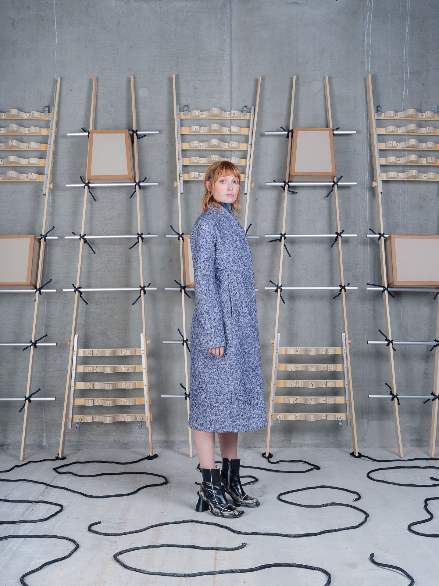 Model wearing Henrik Vibskov Shell Coat in Blue Pebbles side profile view