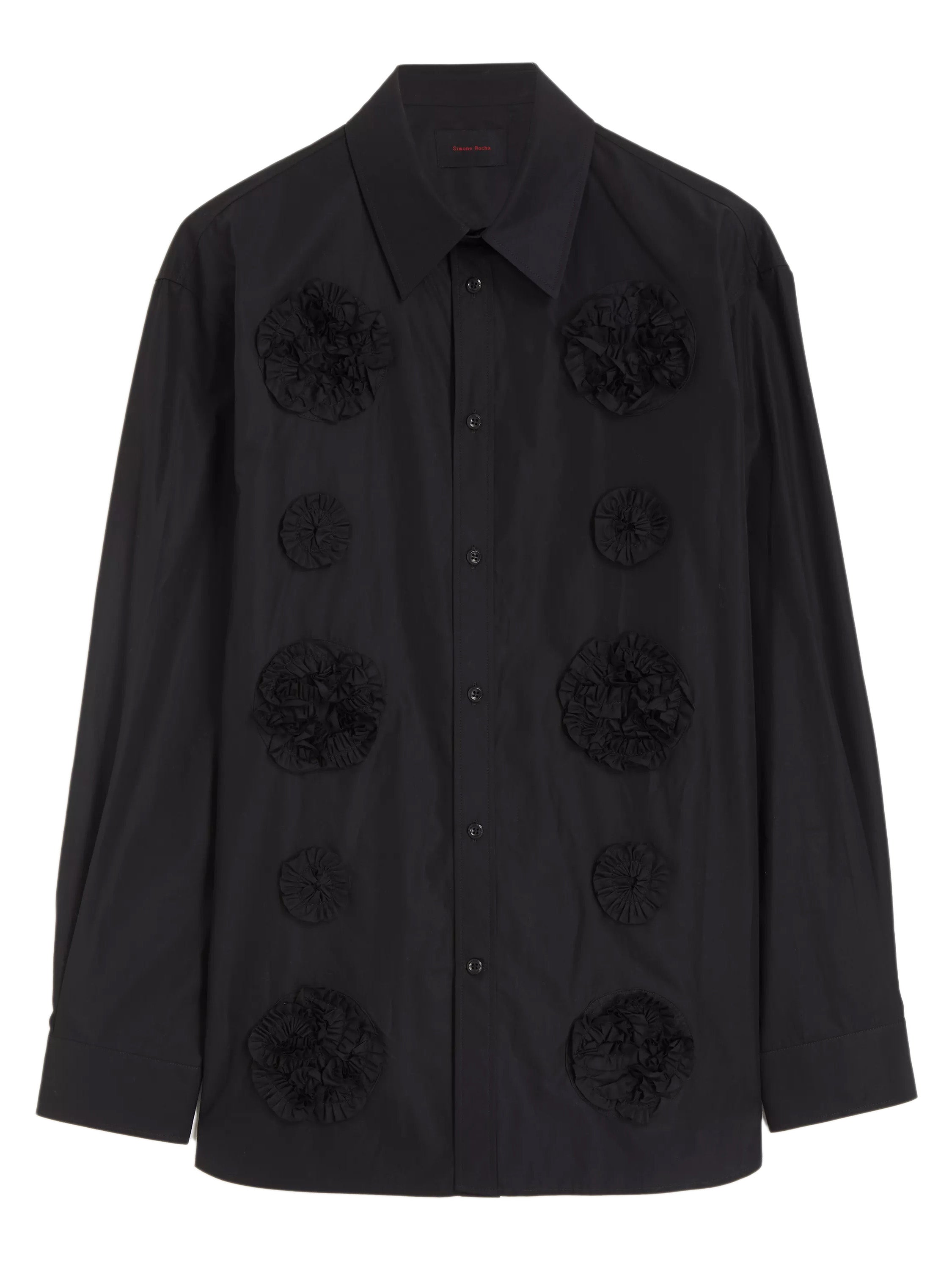 Front view of a black shirt with flower frill details from Simone Rocha on a white background