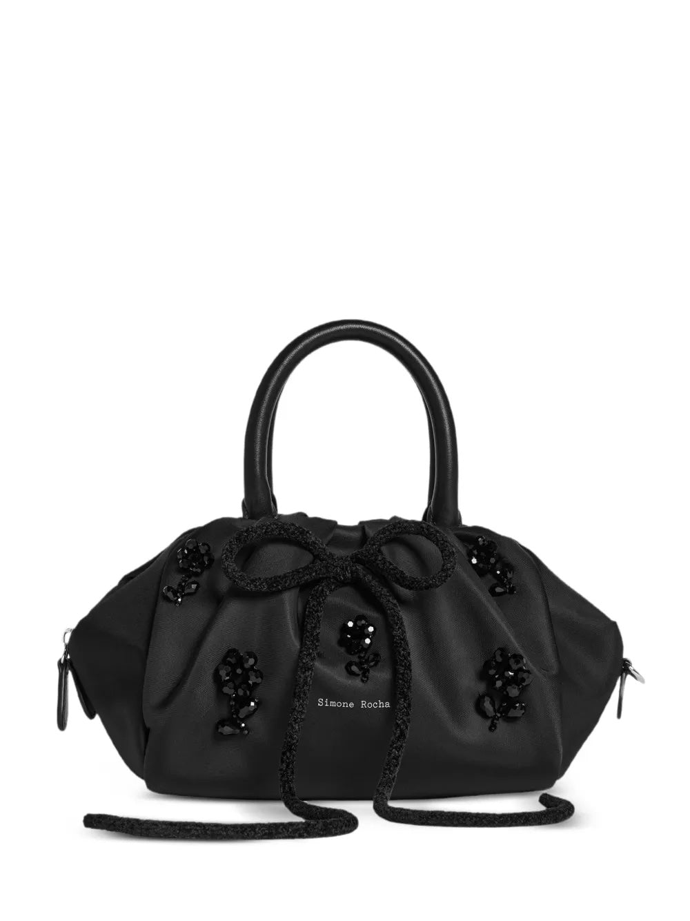 Black handbag from Simone Rocha with floral embellishments on a white background