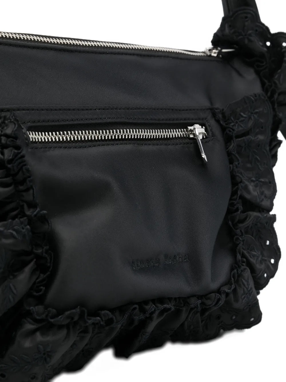 Close-up of the Simone Rocha shoulder bag showing the embroidered daisy motif and broderie anglaise trim.