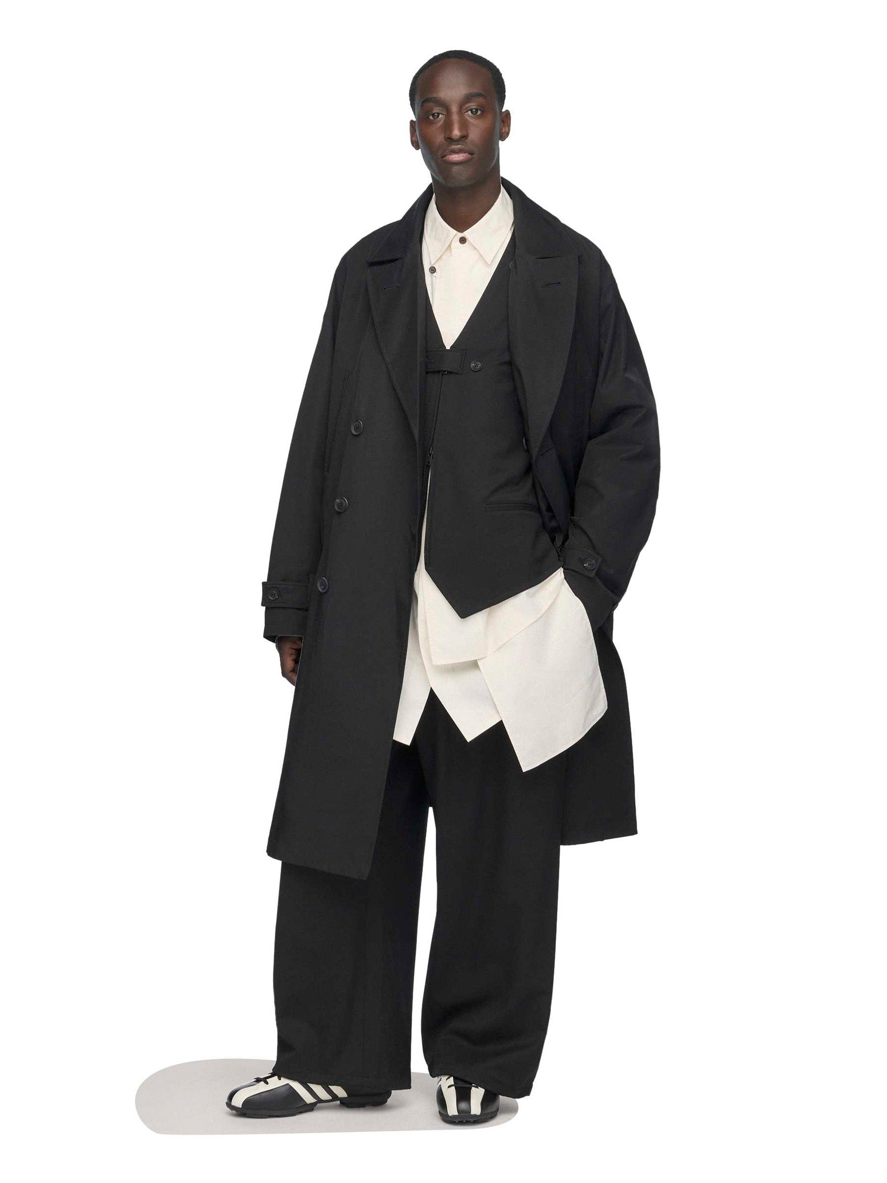 Model styling the Y-3 Spun Nylon Cabban Coat in Black with layered garments.