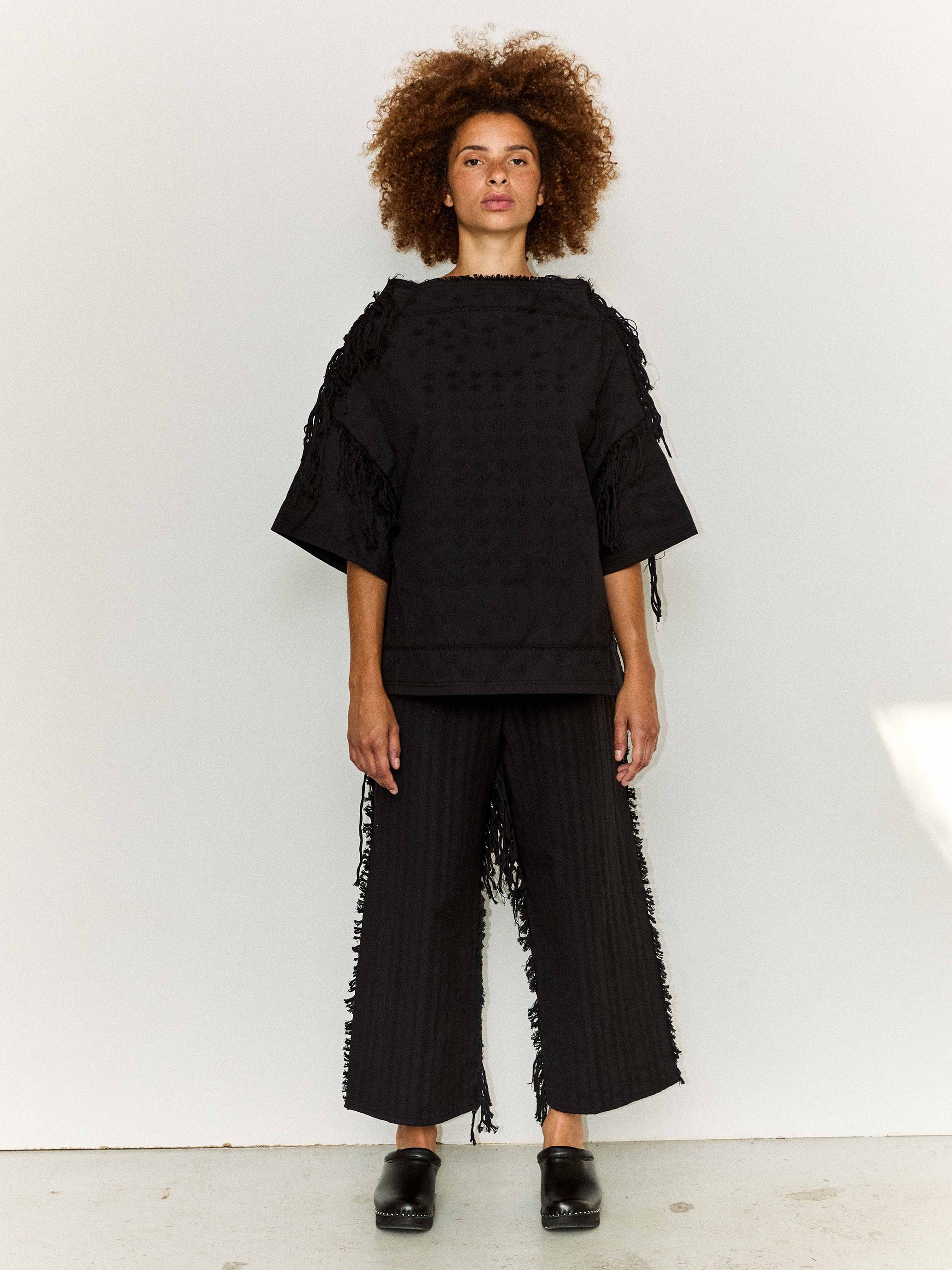 Model wearing the Stem Flower Tee in black, front view