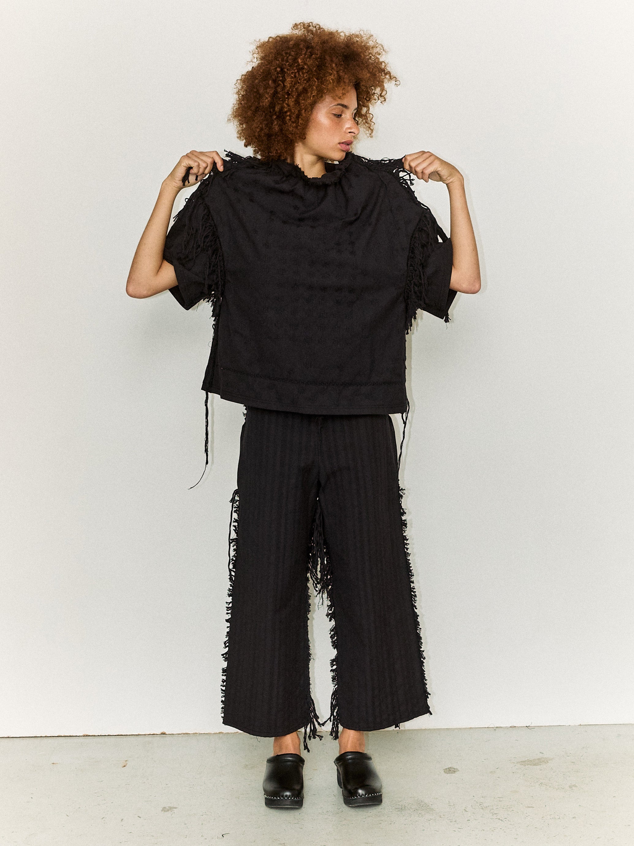 Model wearing the Stem Flower Tee in black, front view