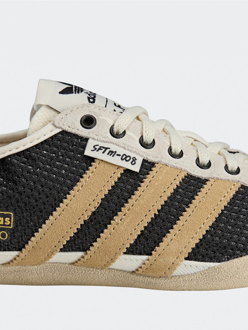 Adidas Tokyo W SFTM in Black/Beige/Gold - three-quarter side view showing gold three stripes and black textured silhouette