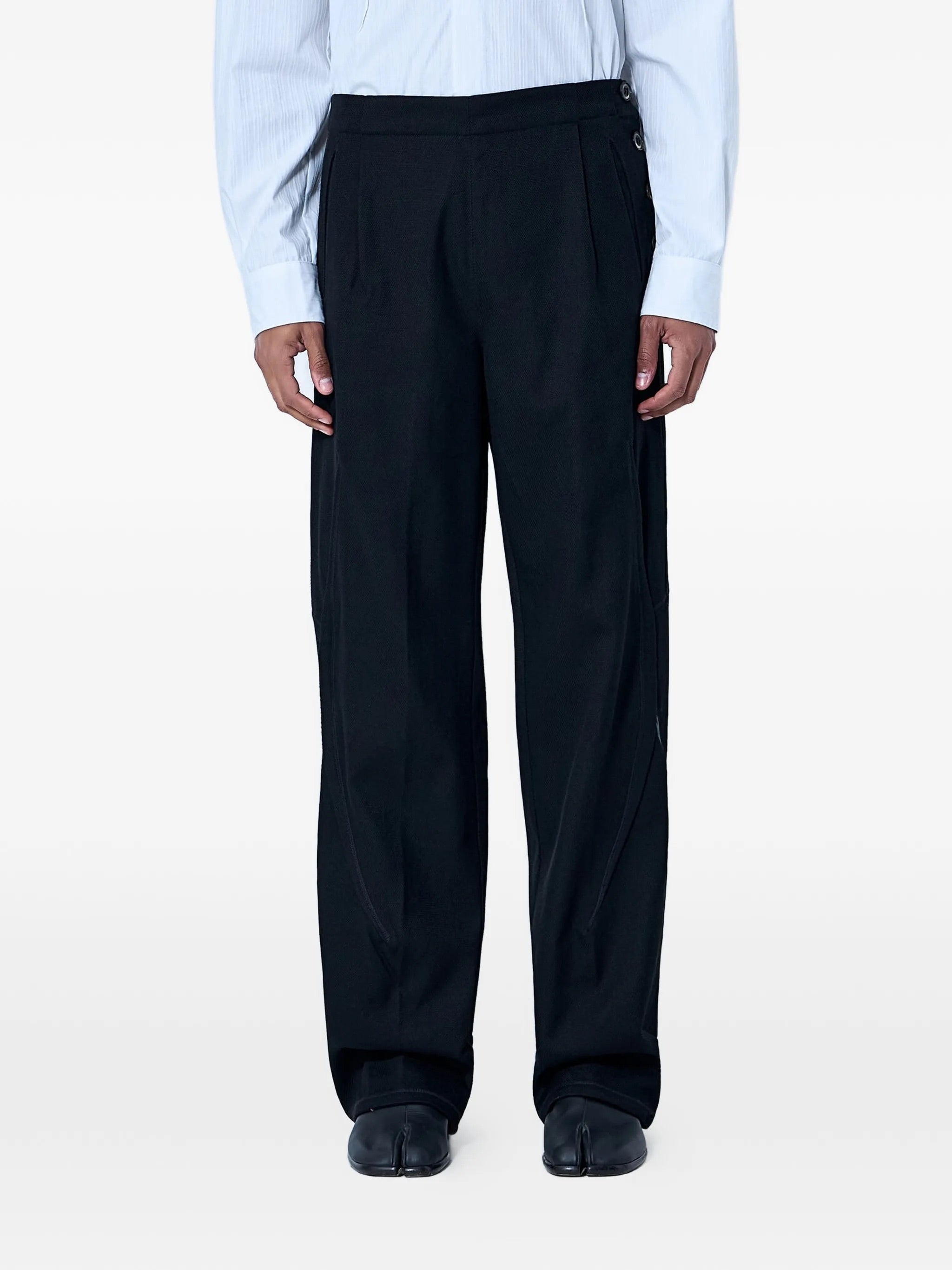 Front view of the model wearing the Kiko Kostadinov Vig K-Dart Trouser in Space Black.