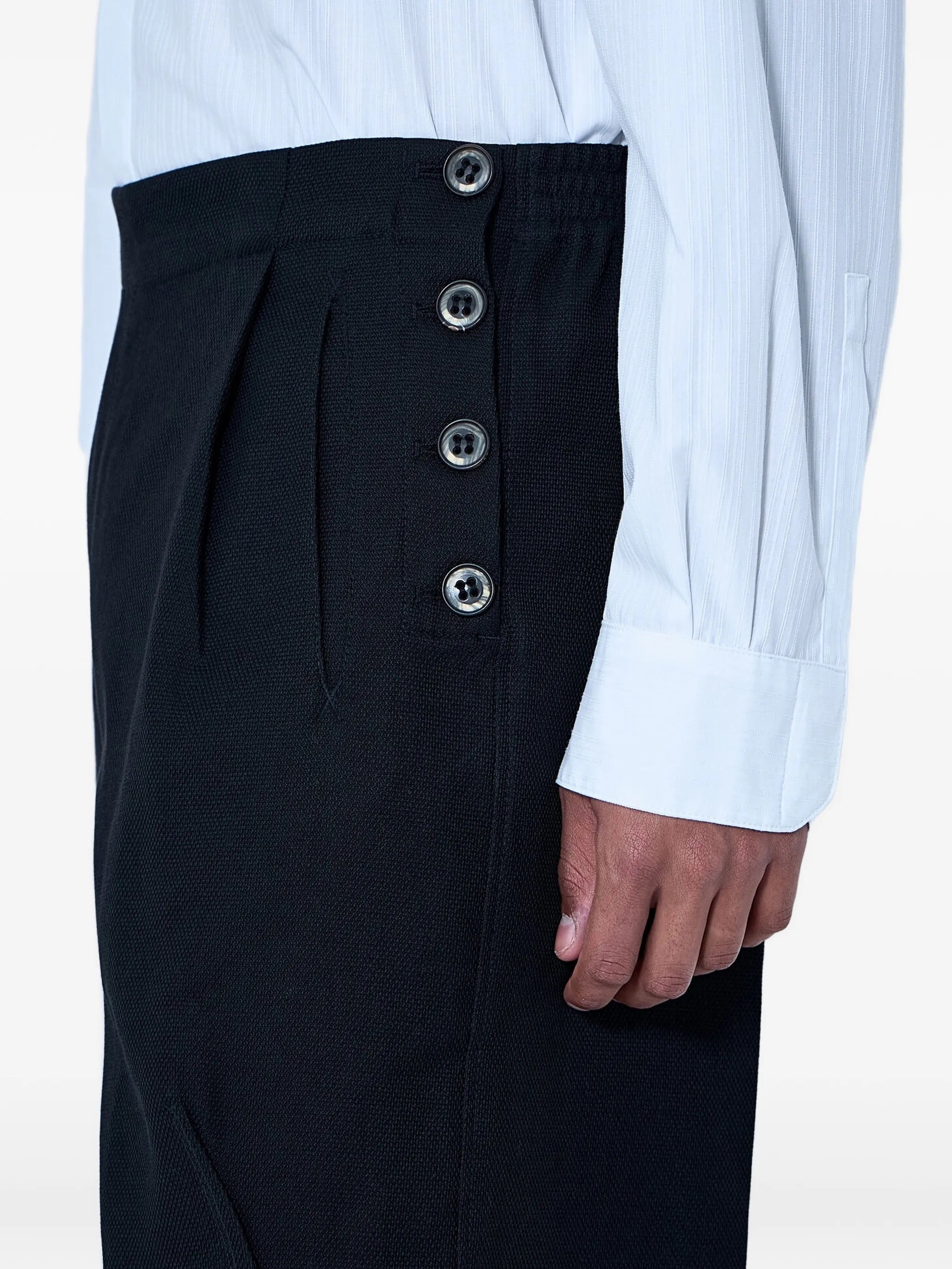Close-up of the side button detailing on the Kiko Kostadinov Vig K-Dart Trouser.