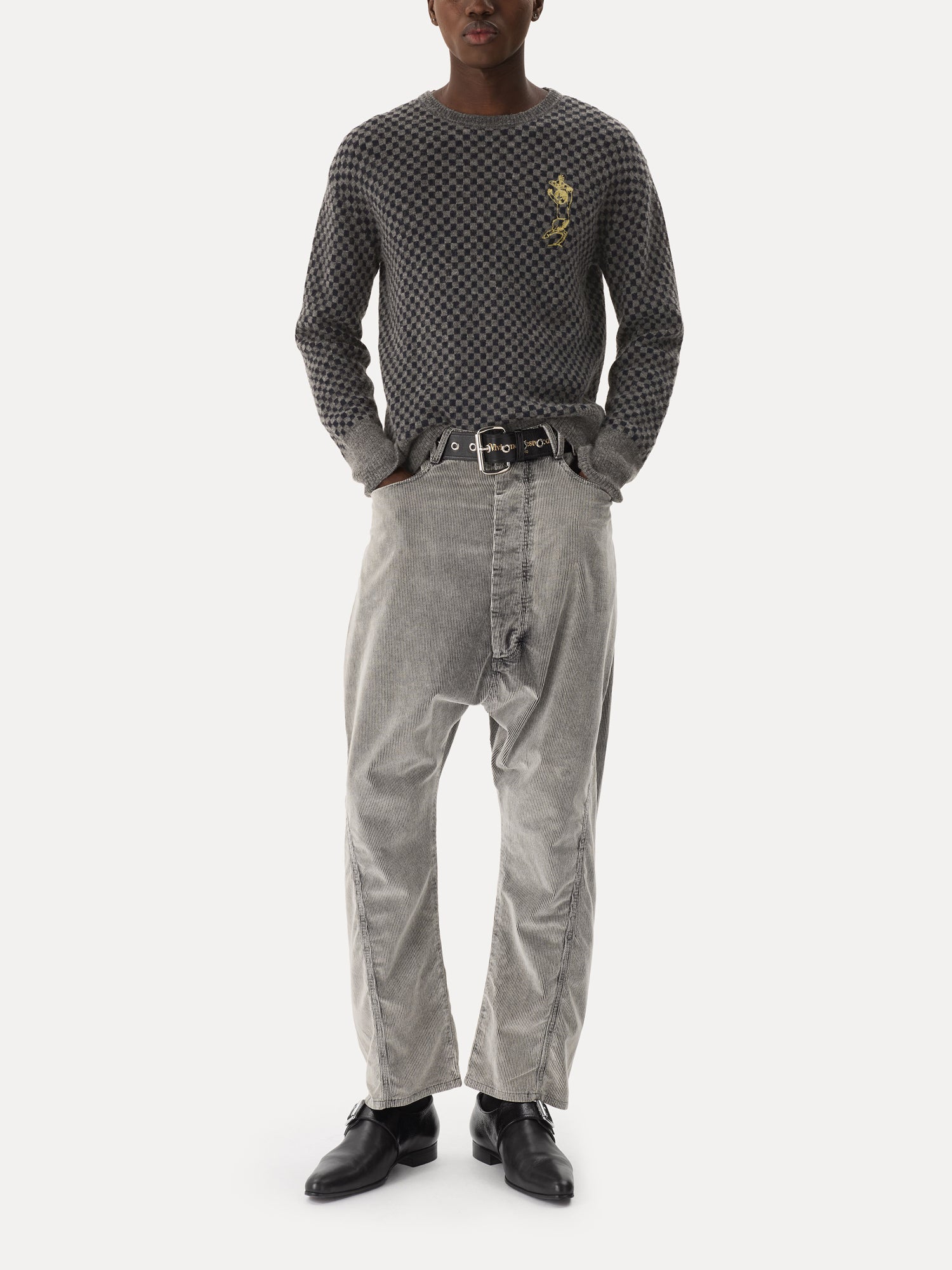 Model wearing Vivienne Westwood Checkmate Jumper in grey melange and navy check with rounded neckline, long sleeves and satyr chest embroidery