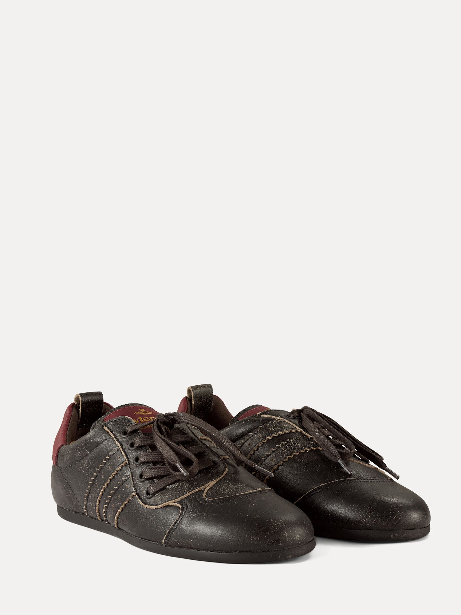 Pair of Vivienne Westwood Drunken Trainers in dark off black leather with burgundy accents, serrated stripes and off-centre laces