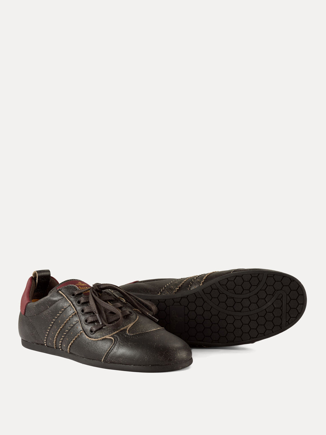 Vivienne Westwood Drunken Trainer in Off Black showing textured black sole, distressed leather upper and low-top silhouette