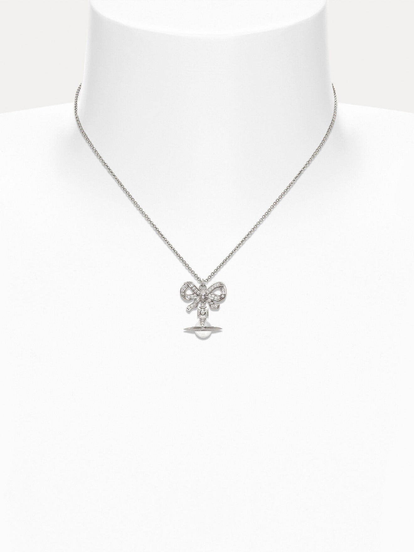 Necklace with a bow pendant on a mannequin against a white background