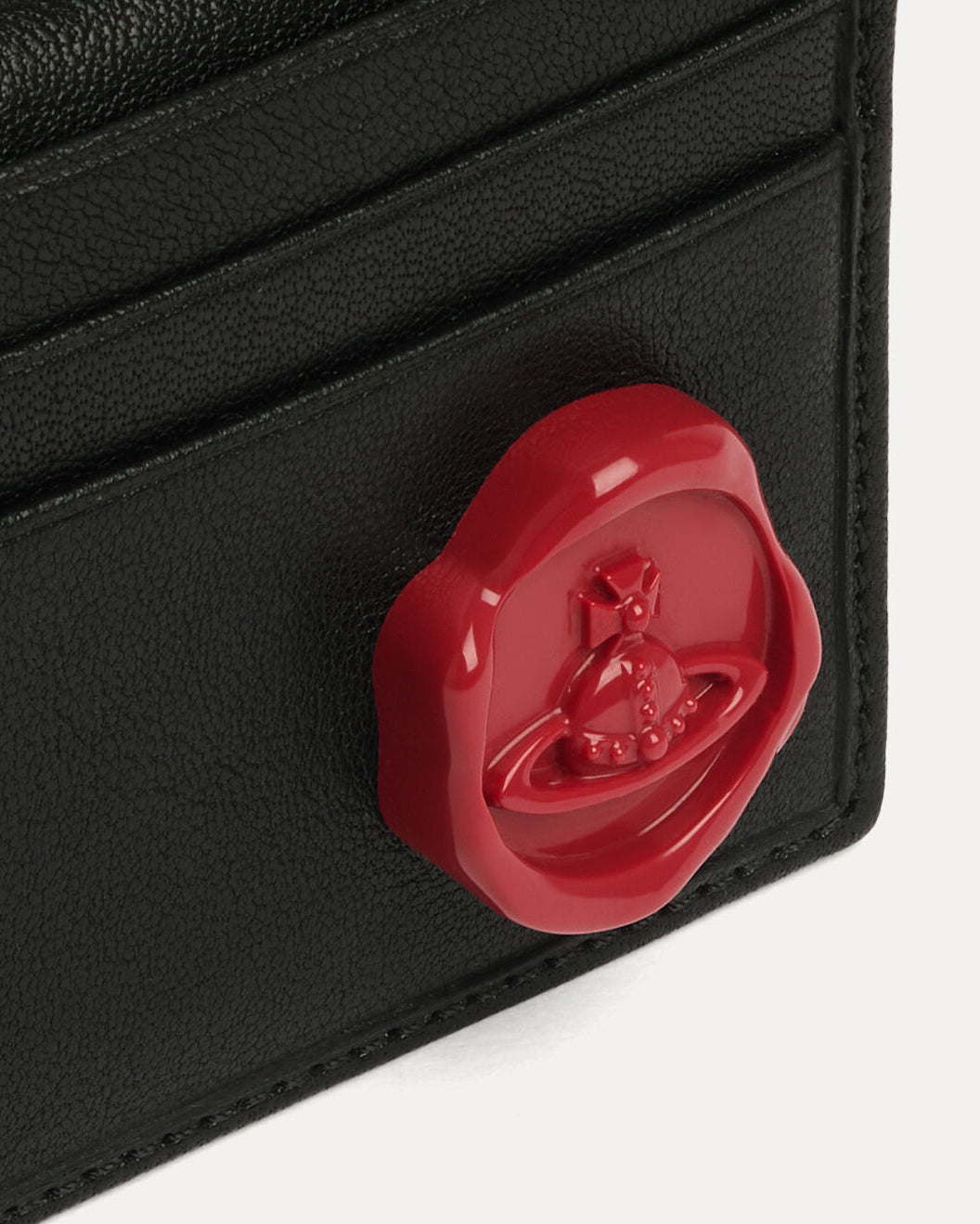 Close-up of the Vivienne Westwood Man Card Holder in Black showing the red wax-seal orb detail on the front.