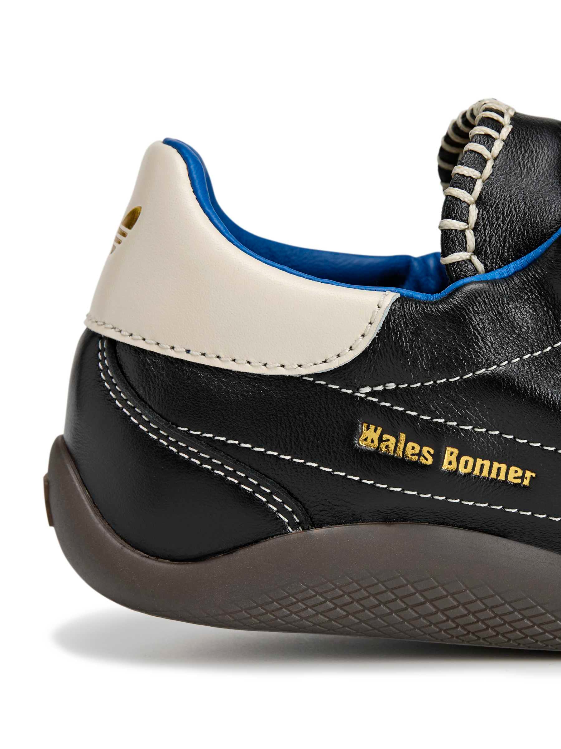 Close-up of Wales Bonner co-branding and gold-tone eyelets on the Karintha OG in Core Black Wonder White Lush Blue leather sneaker – Wales Bonner x Adidas SS26