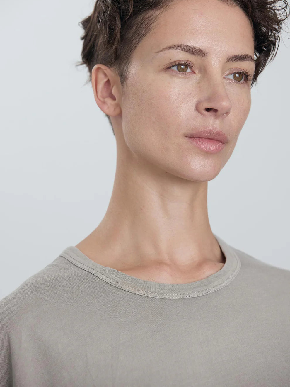Black Crane Wide Short Sleeve Tee in Grey - close portrait view on model showing crew neck and Japanese textured jersey fabric