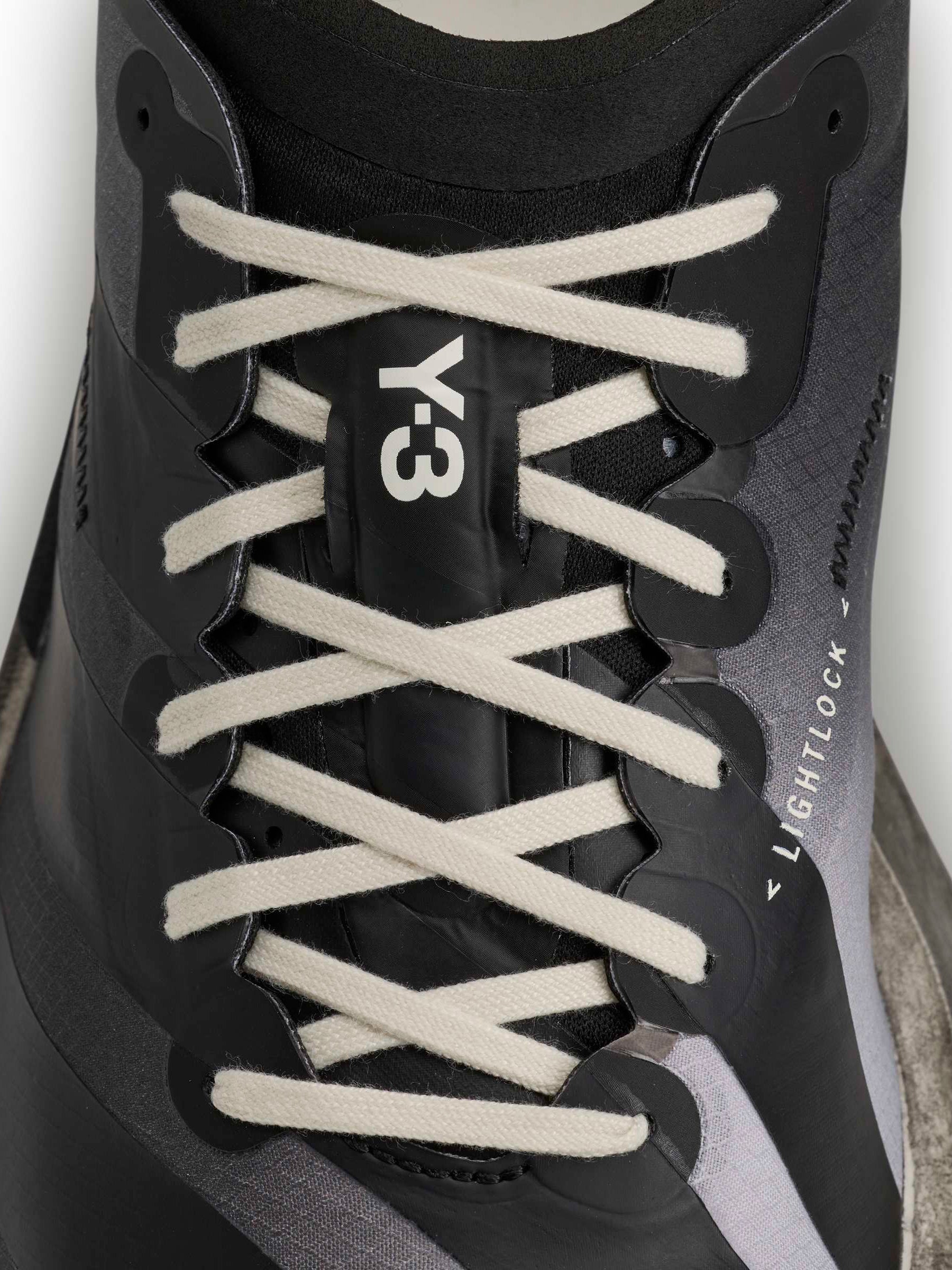 Y-3 Adios Pro 4 lace detail close-up, off-white rope laces in cross pattern, Y-3 logo branding, black Lightlock upper texture