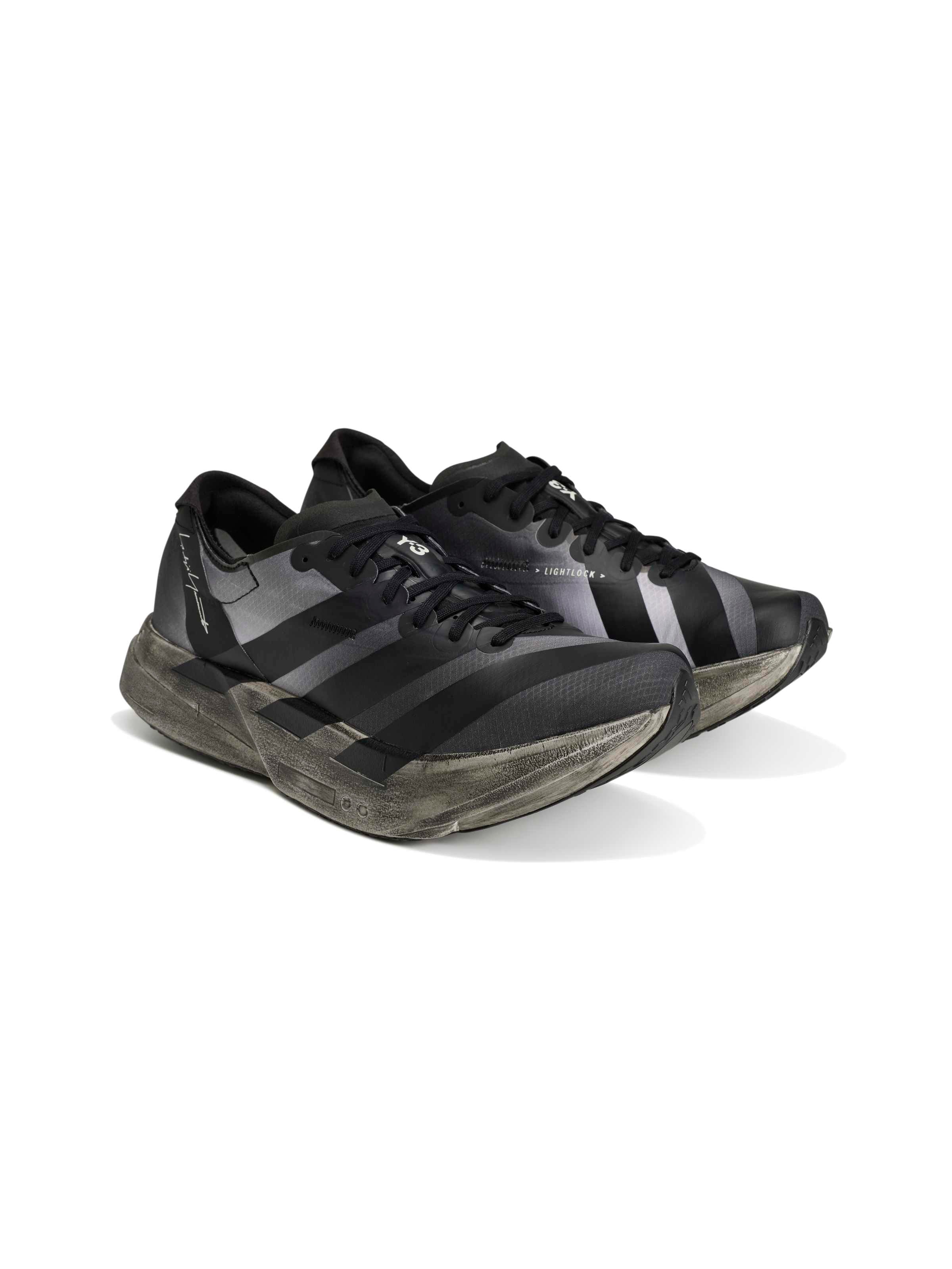 Y-3 Adios Pro 4 three-quarter rear view, heel and midsole profile, distressed finish, black upper, grey five 3-Stripes, rubber outsole
