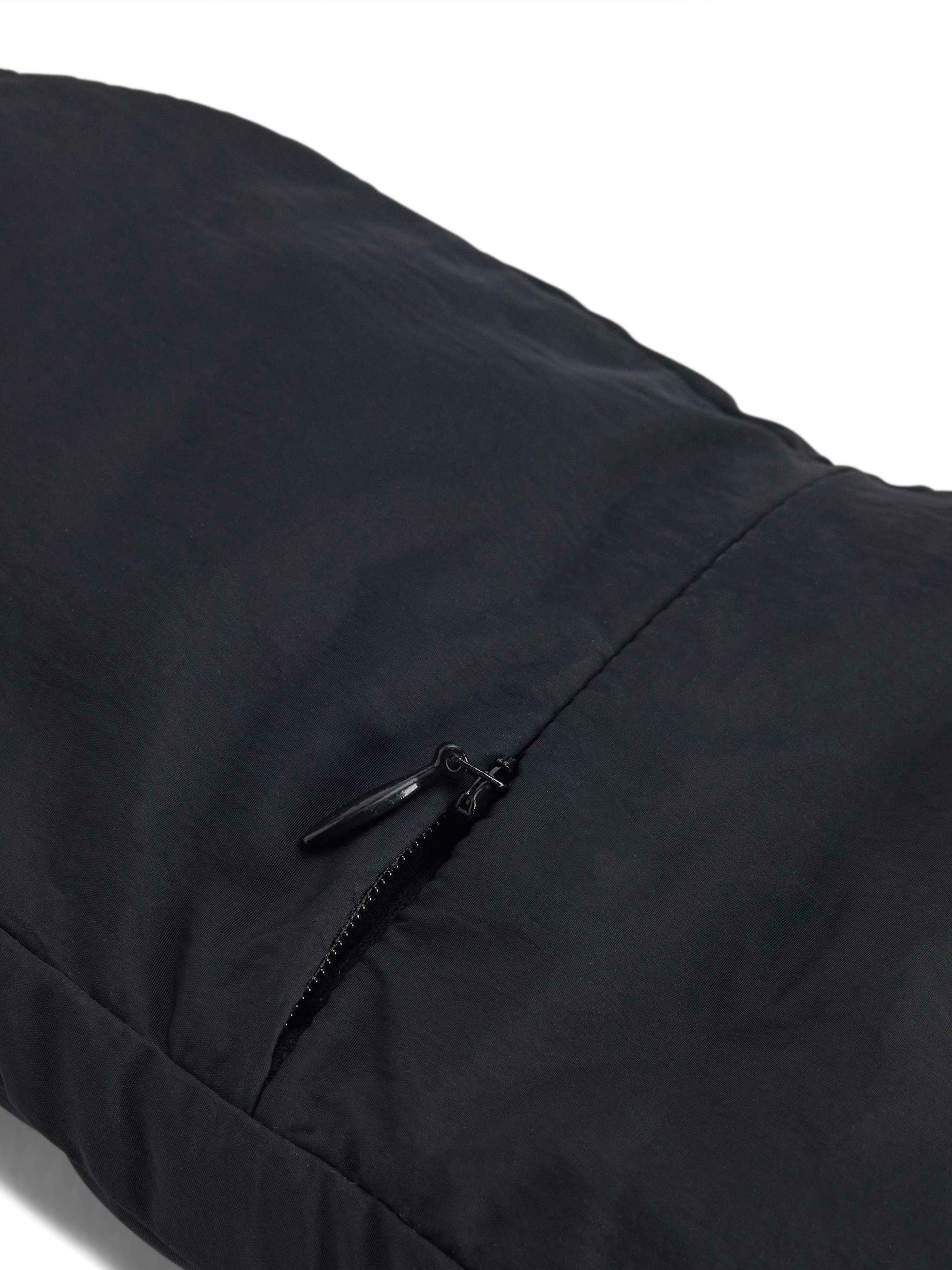 Close-up of a black glove with a zipper on a white background