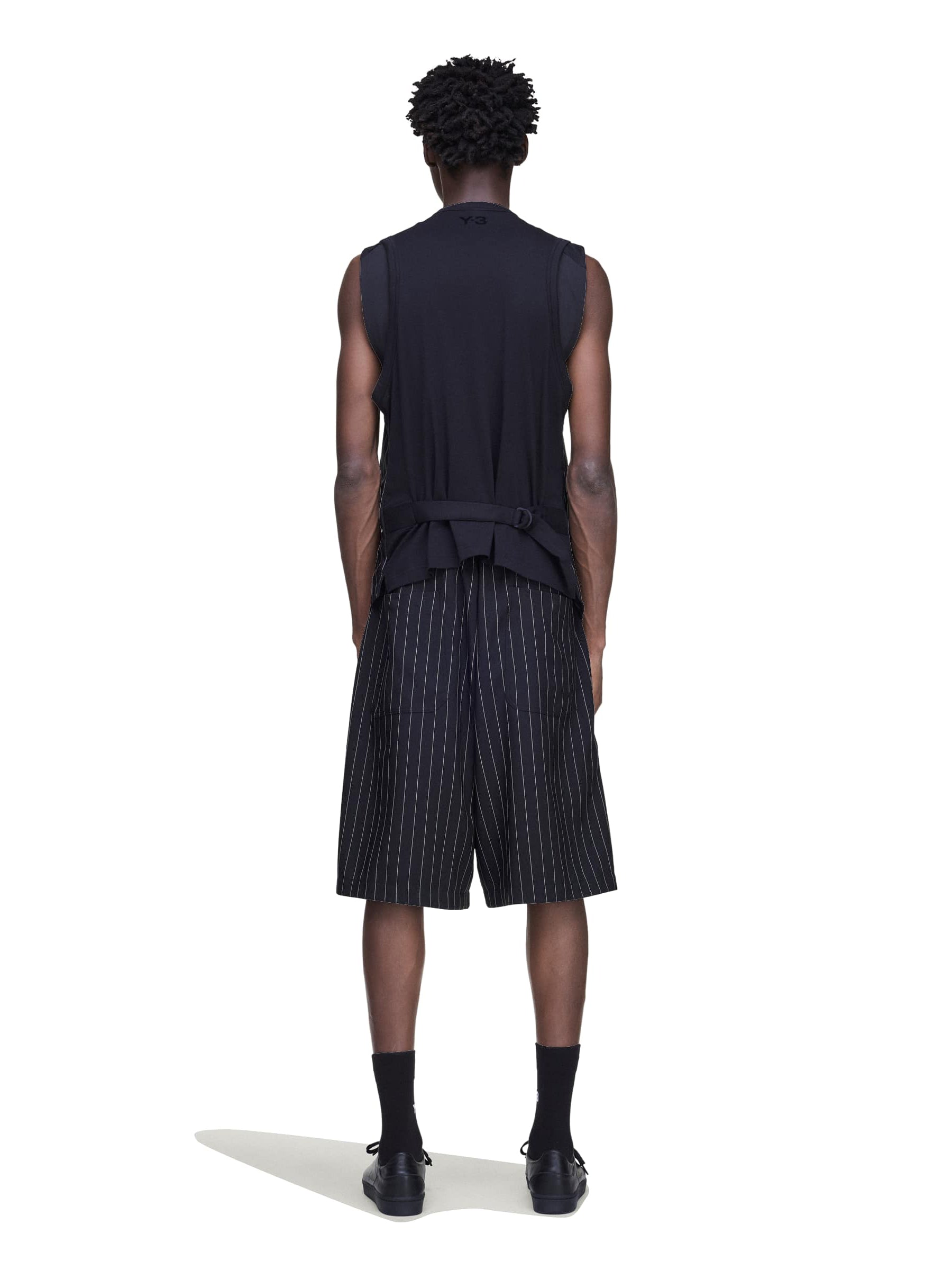 Back view of a male model wearing the Y-3 Pinstripe Sport Uniform Shorts in Black, highlighting the loose fit and clean back design.