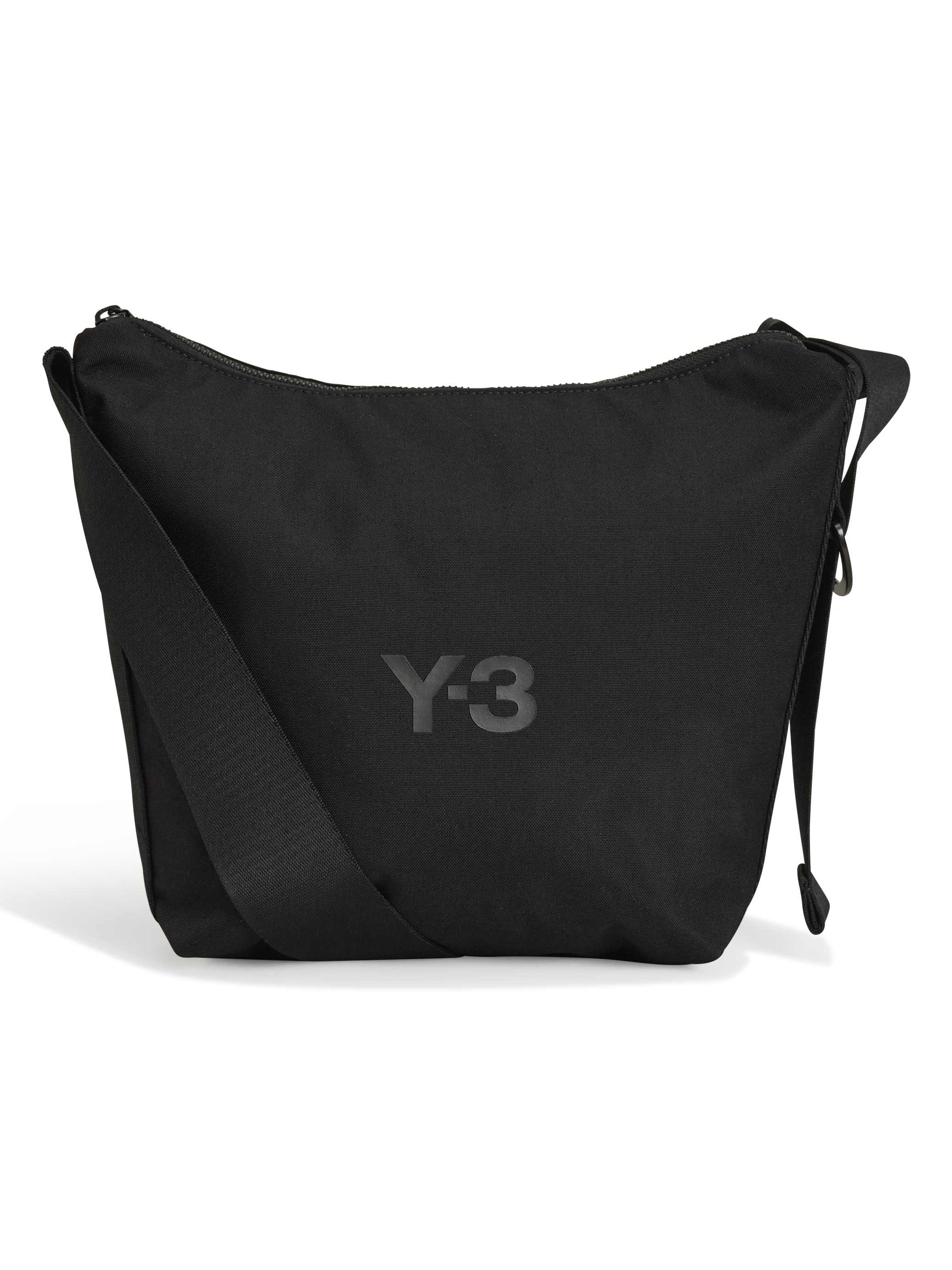 Front packshot of the Y-3 Small Crossbody Bag in Black, showing the durable CORDURA® fabric, front zip pocket, and metallic buckle closure.