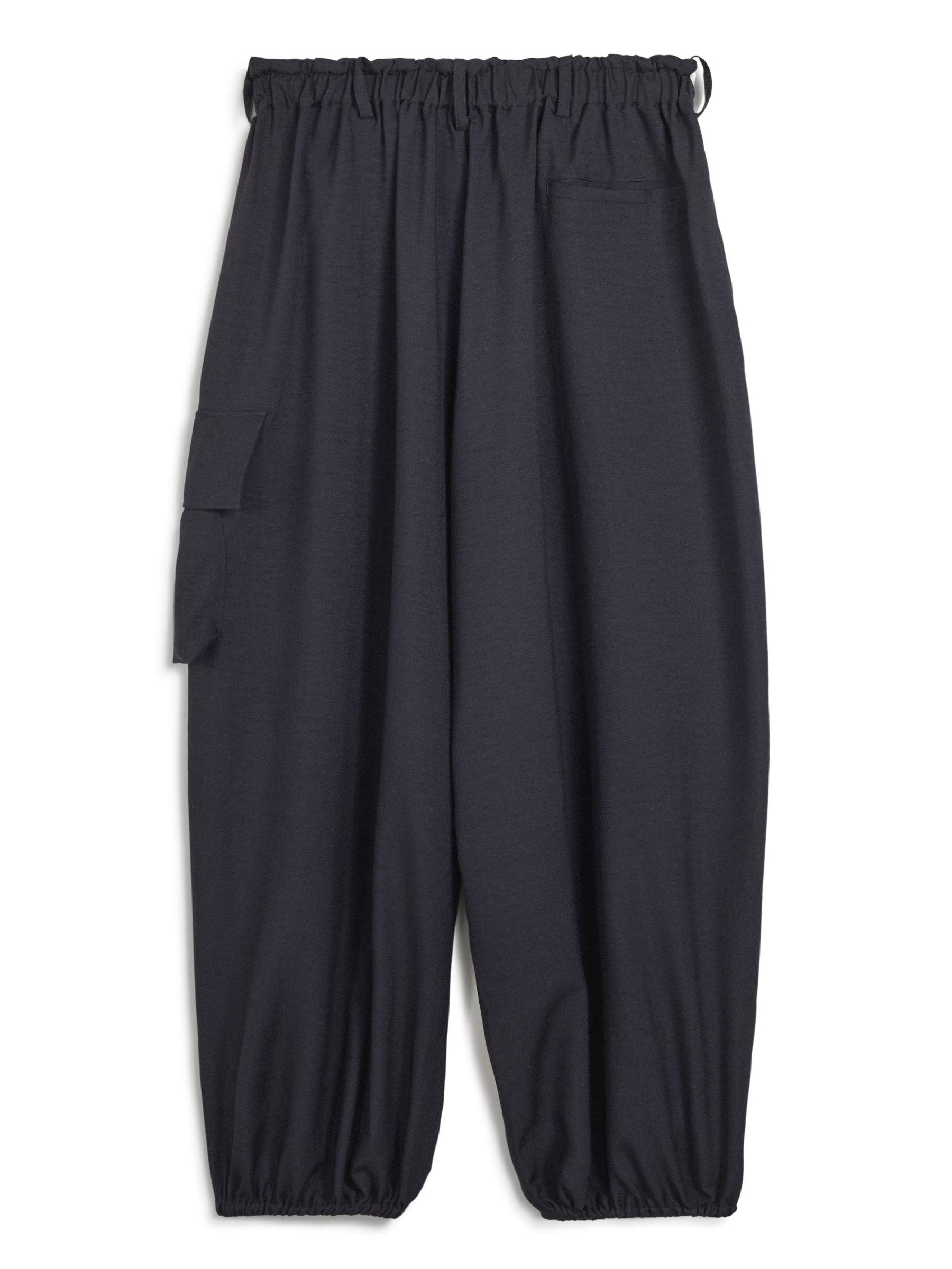 Back packshot of the Y-3 Sport Uniform Wide Cargo Trousers in Black, highlighting the wide-leg fit, rear flap pockets, and satin heat-transfer Y-3 logo.
