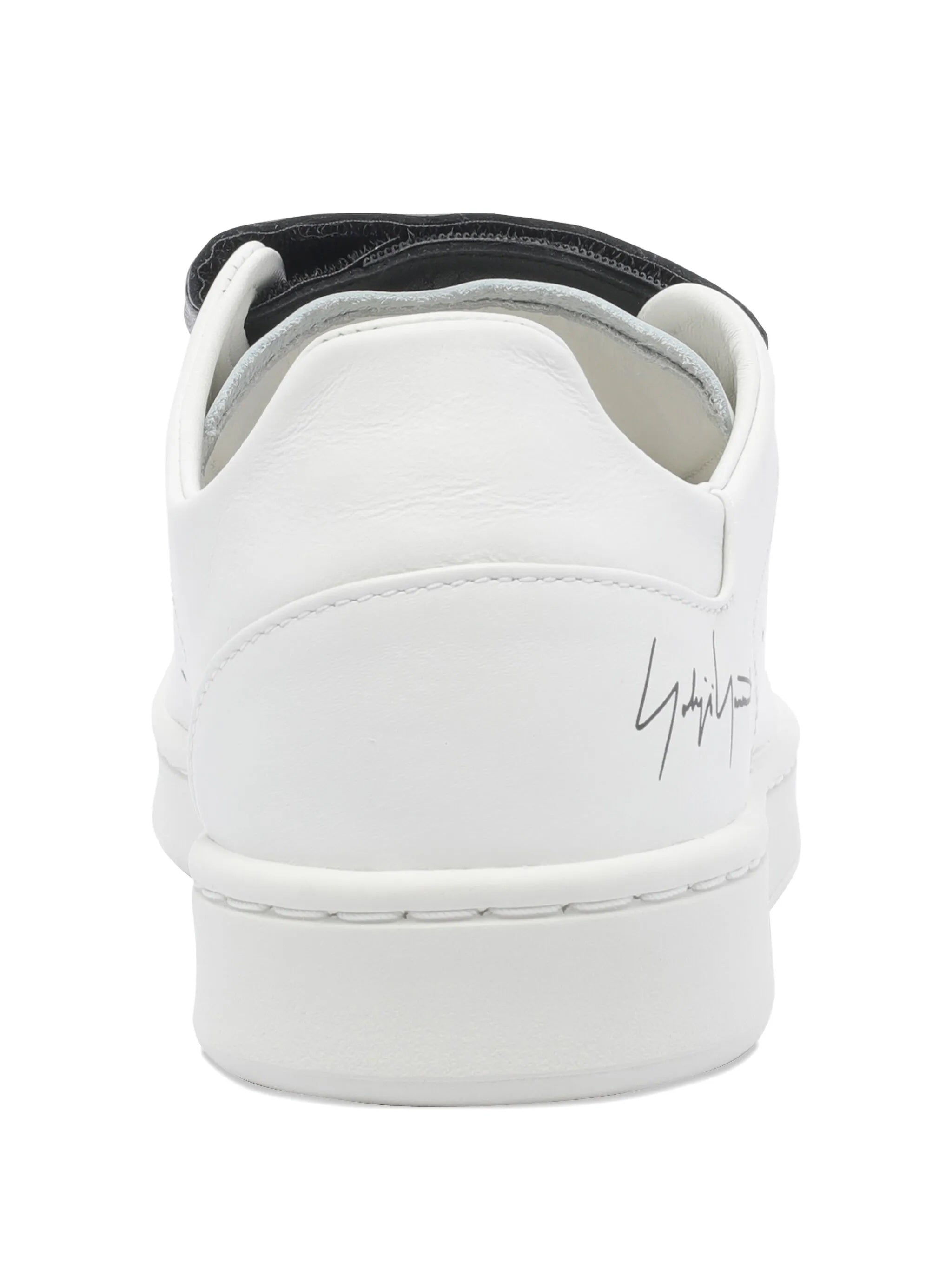 White sneaker with black interior on a white background