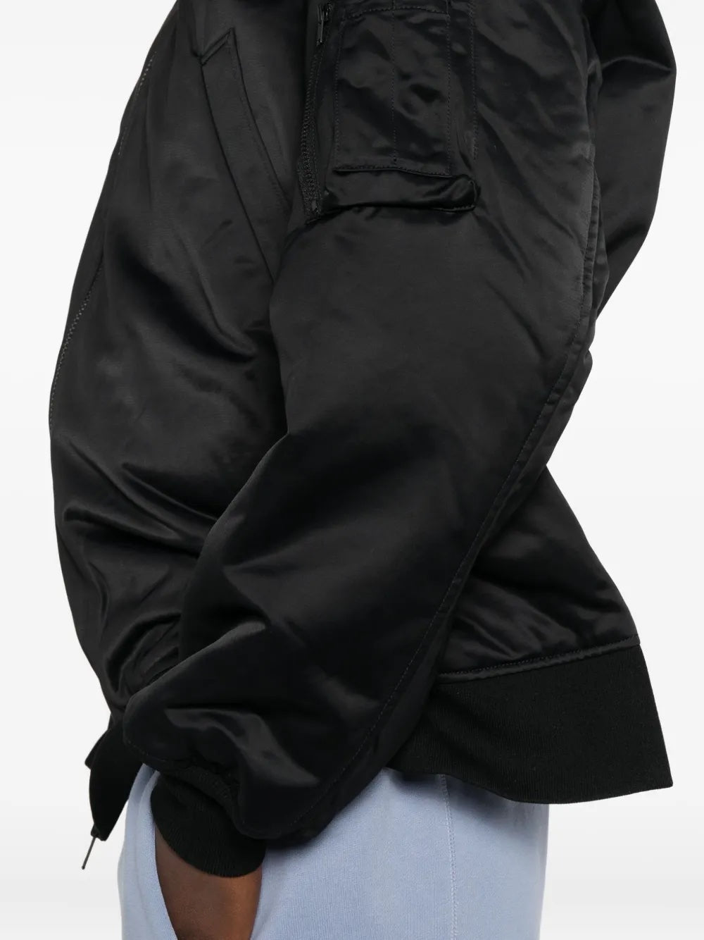 Black jacket worn by a person on a white background