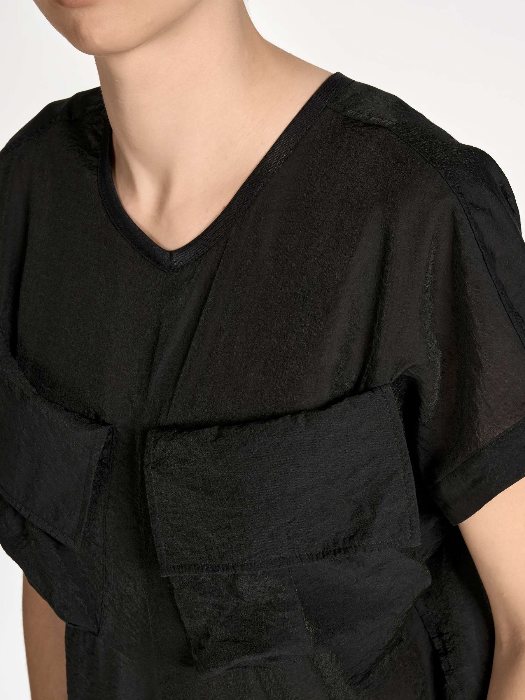 Close-up of the upper front of the Y-3 Women’s Utility Dress in Black on a model, highlighting the neckline and fabric texture.